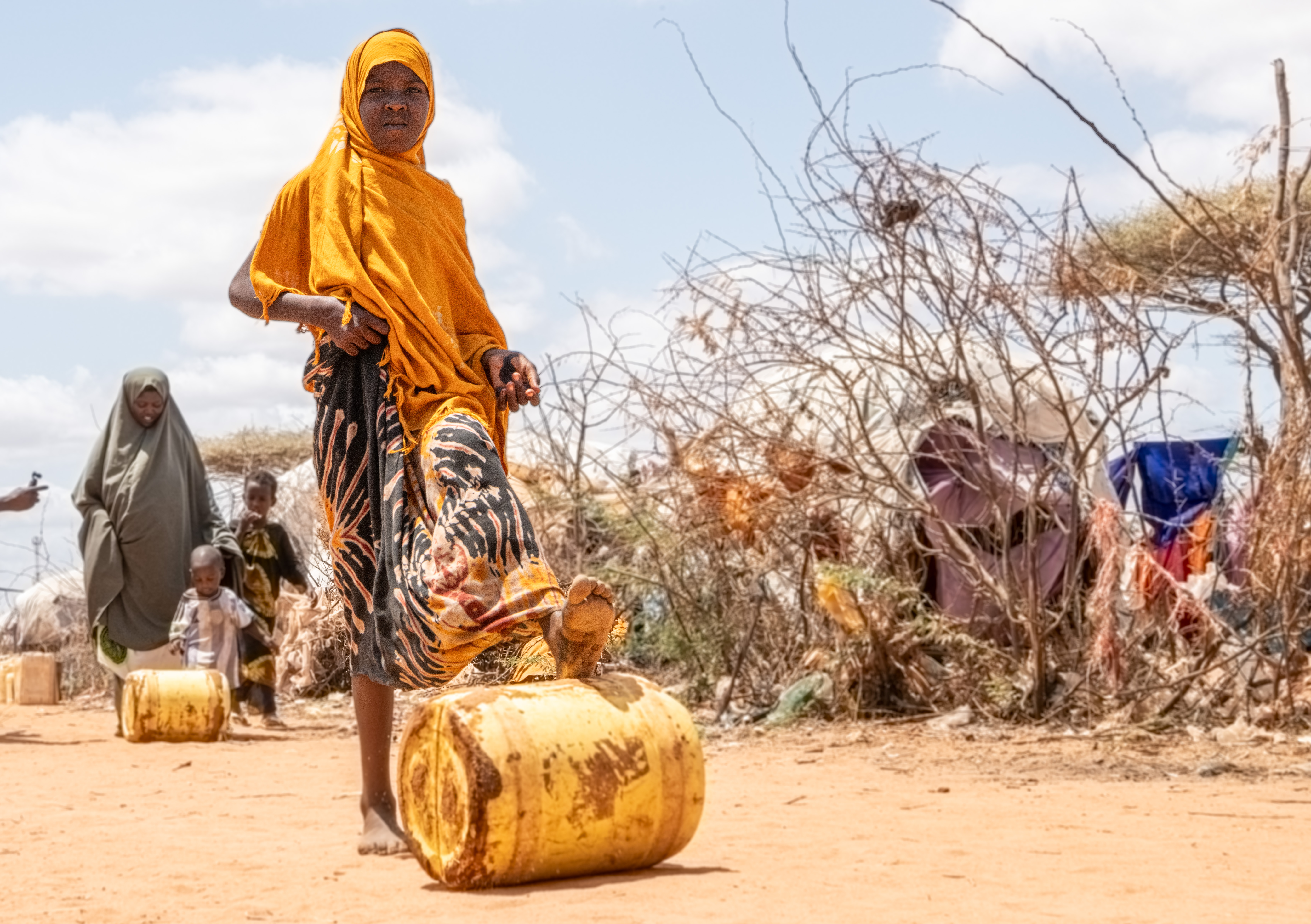 Nafiso Ibrahim, 11, rolls a jerrycan of clean water she has fetched at a water stand in Dagahaley refugee camp. UNHCR and partners are providing humanitarian assistance including access to clean water to all newly arrived refugee families, most of whom escaped hard-hitting drought in Somalia. [Samuel Otieno/UNHCR]