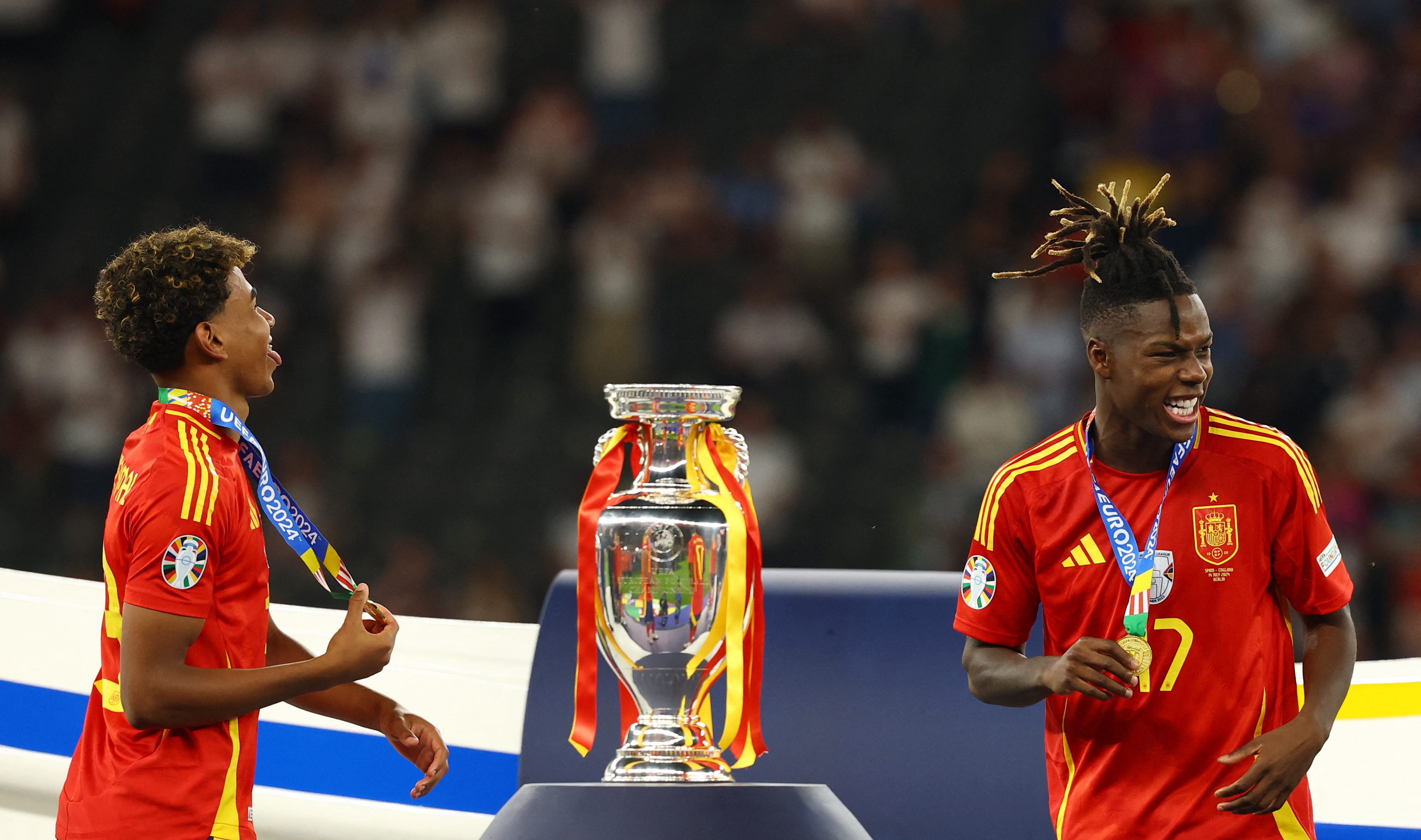 Soccer Football - Euro 2024 - Final - Spain v England - Berlin Olympiastadion, Berlin, Germany - July 14, 2024 Spain's Lamine Yamal and Nico Williams walk past the trophy after collecting their winners medals REUTERS/Kai Pfaffenbach