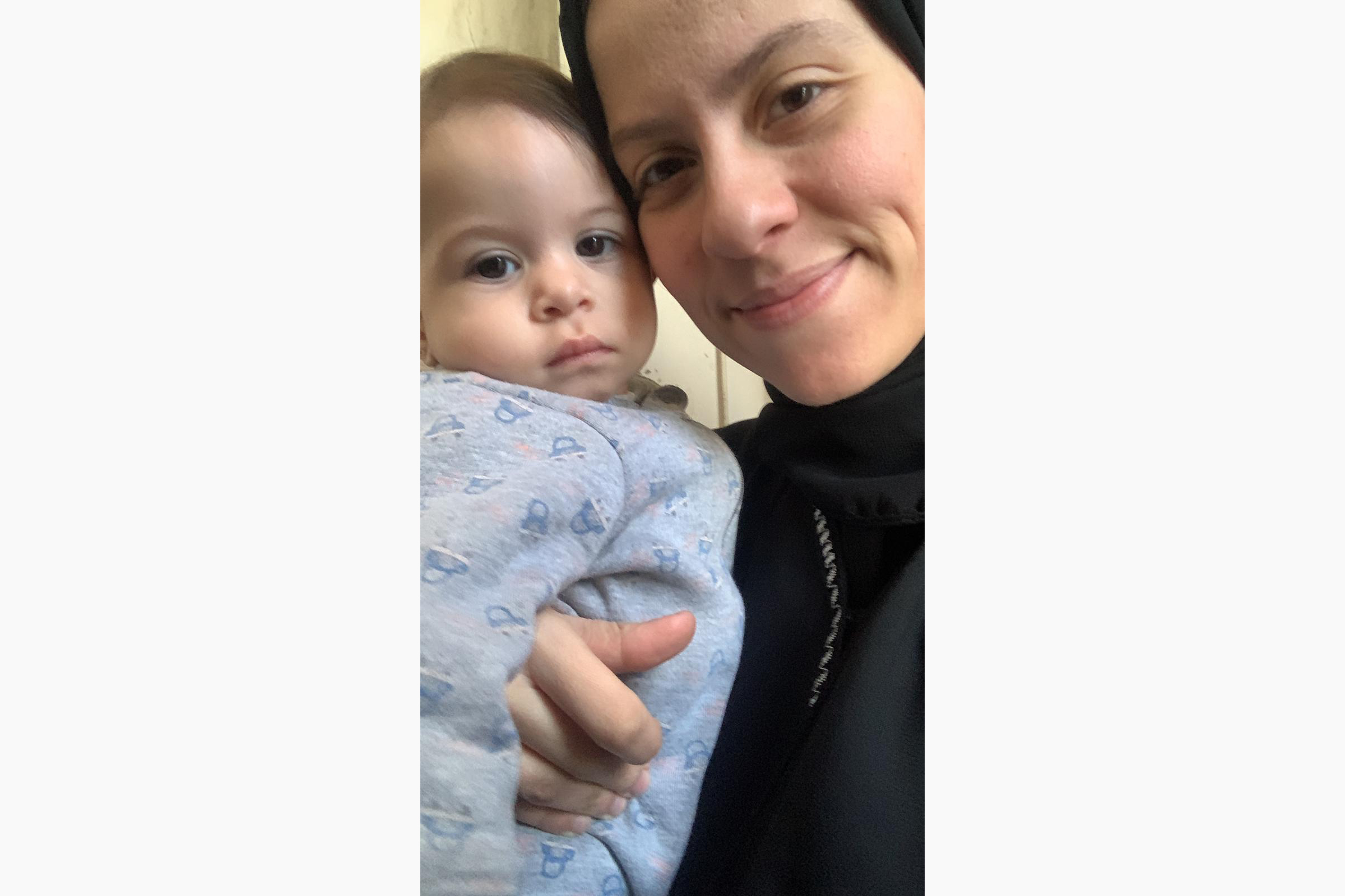 a woman holds her baby