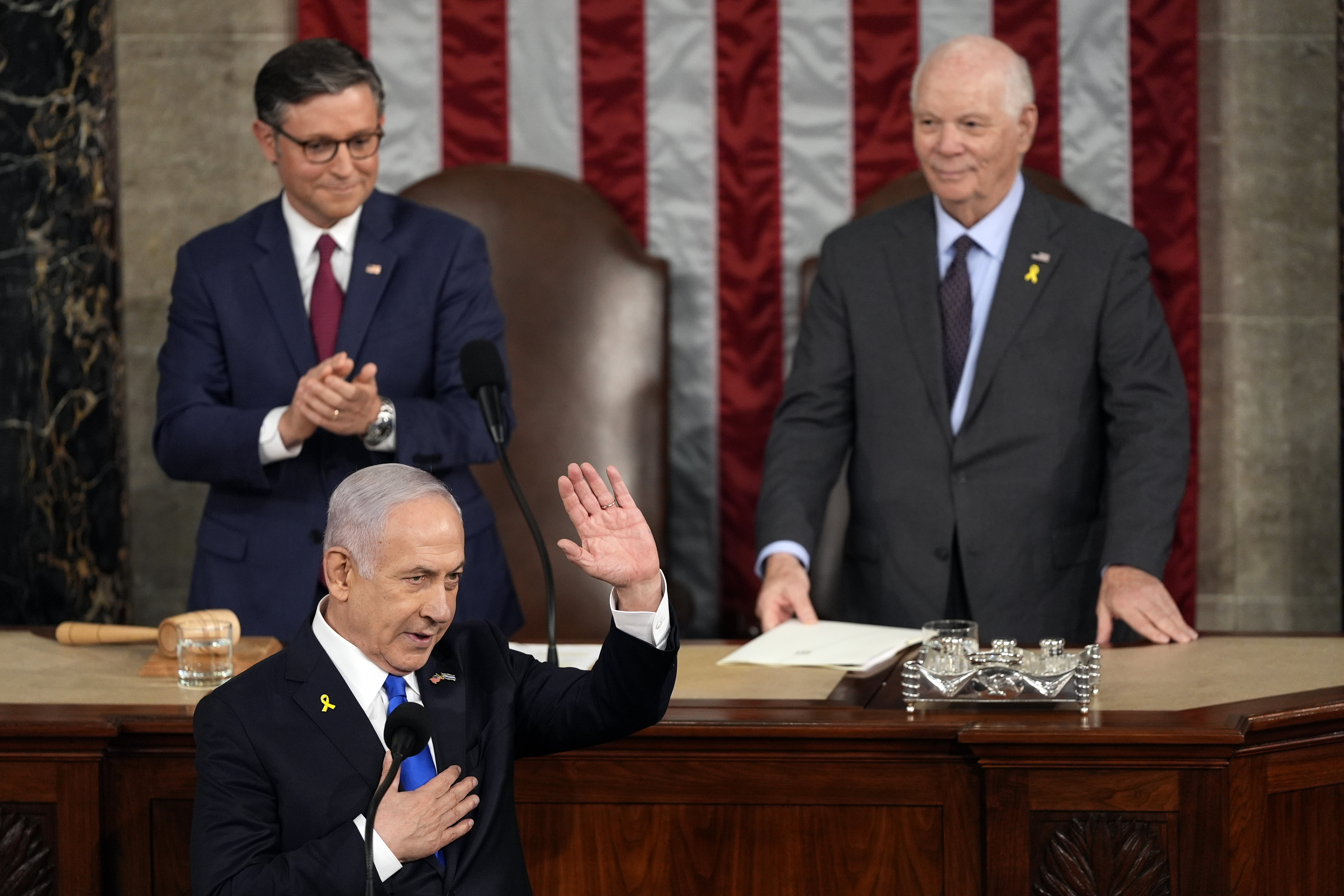 Benjamin Netanyahu waves as he reaches podium at US Congress.