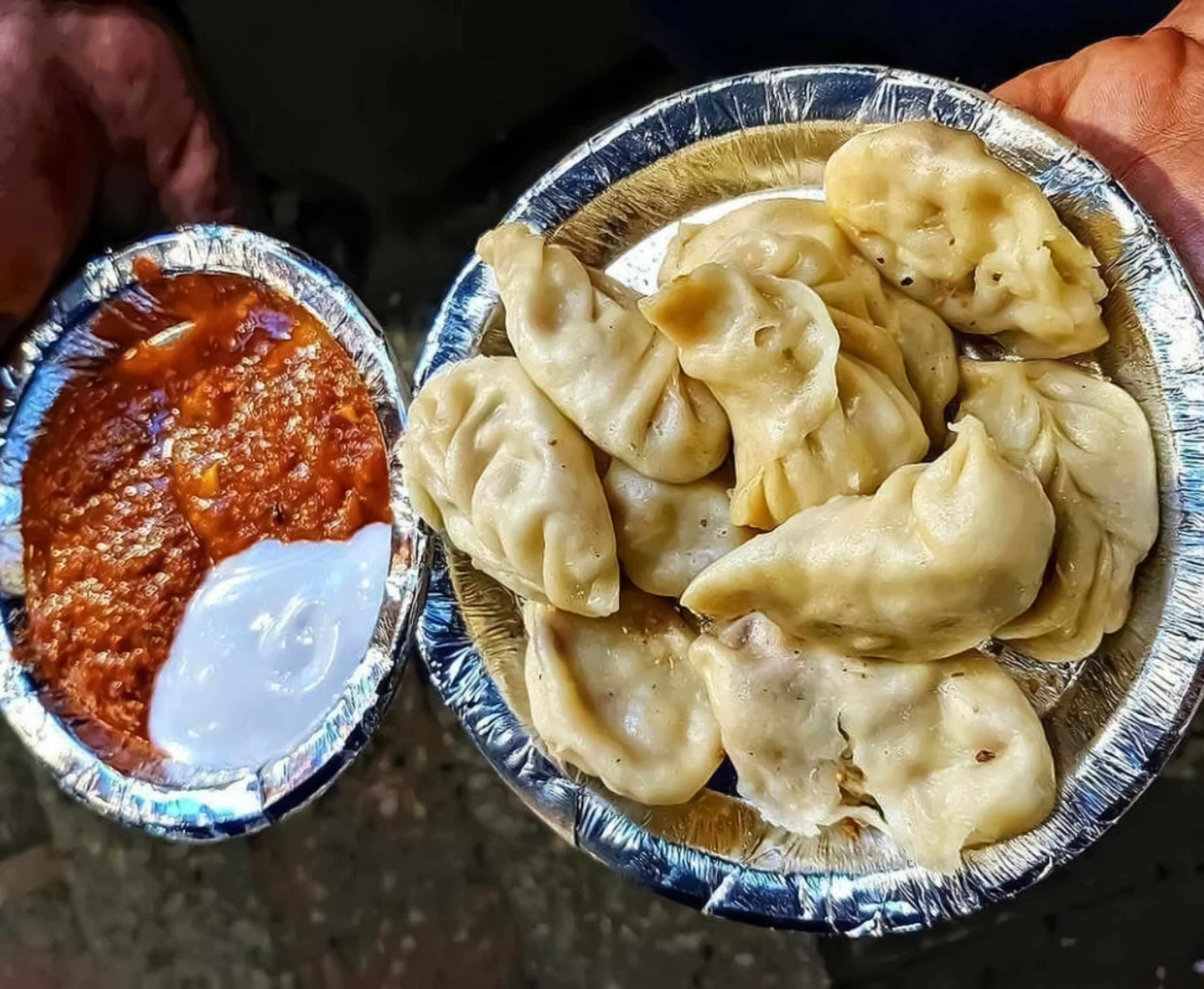 In Delhi and Kolkata, momos are often served with red chilli chutney and mayonnaise [Getty]