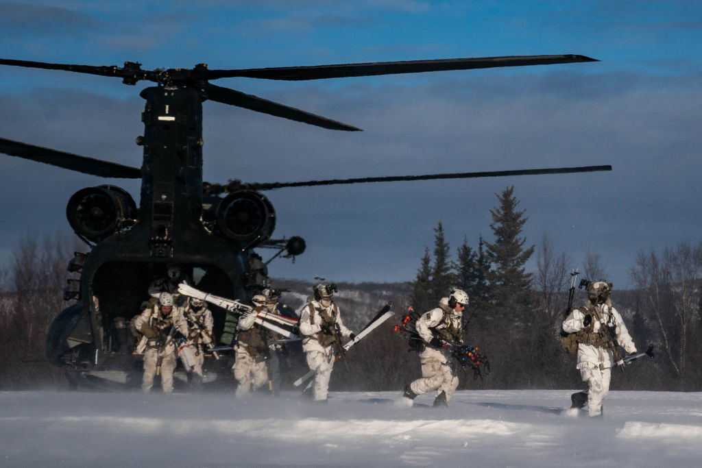 NORTH POLE, AK - FEBRUARY 24: Soldiers from 10th Special Forces Group and Danish special operators from the Jaeger Corps move through the woods to call in fire for HIMARS artillery during training at the Yukon Training Area on Fort Wainwright military base in North Pole, Alaska, Saturday, February 24, 2024. (Photo by Salwan Georges/The Washington Post via Getty Images)