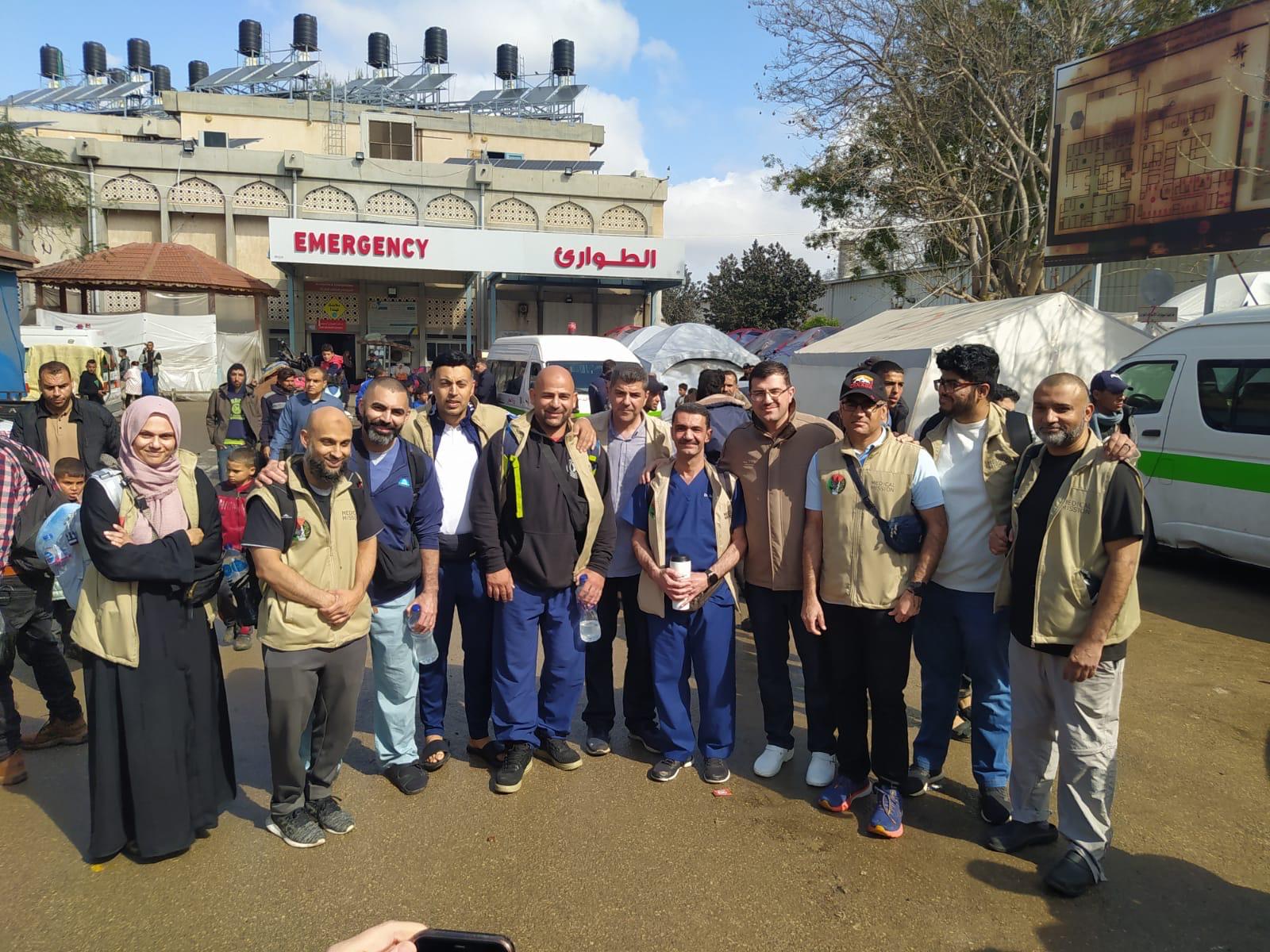 A photo of medical professionals in Gaza, in front of an emergency room entrance.