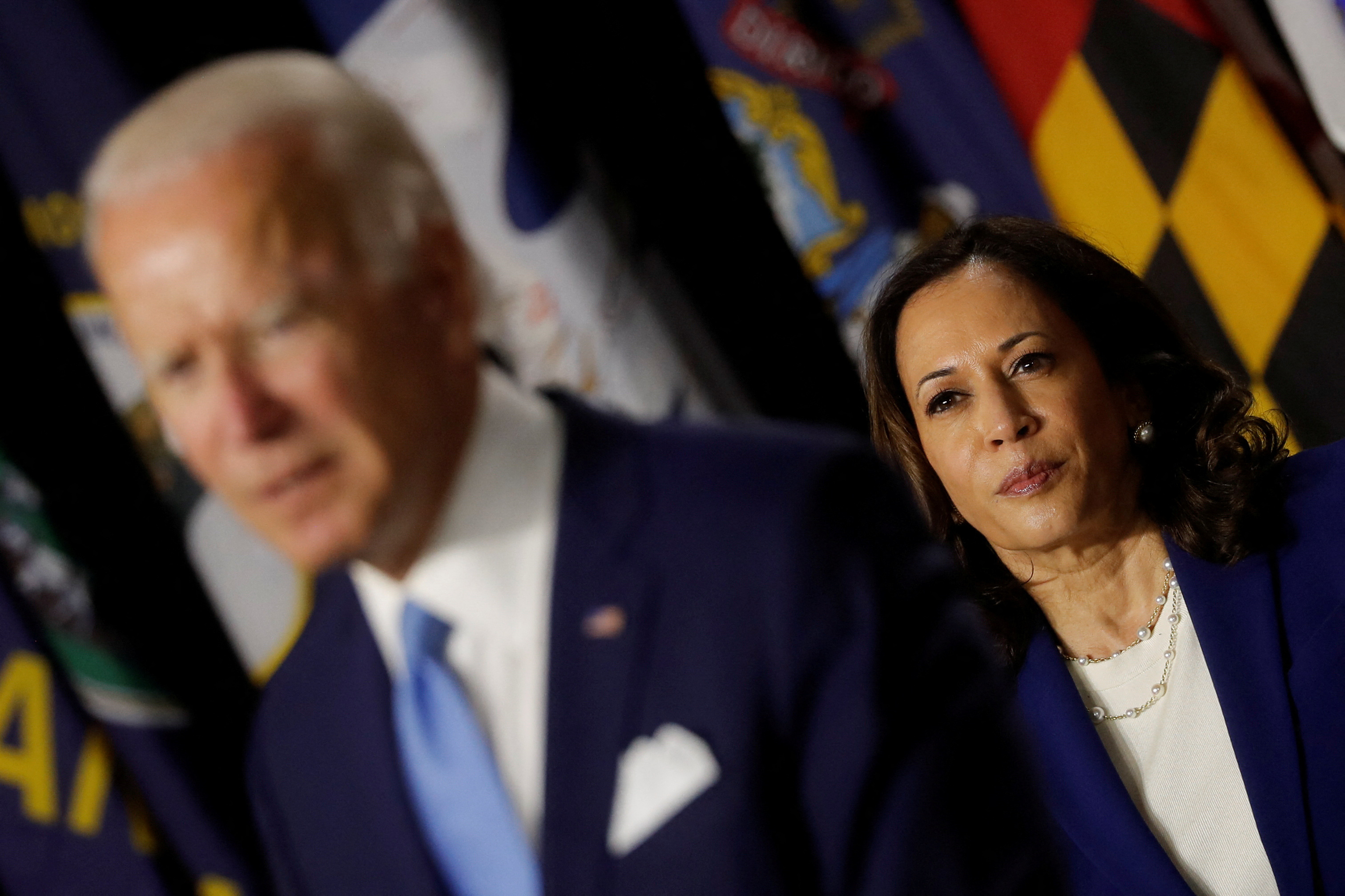 FILE PHOTO: Democratic vice presidential candidate Senator Kamala Harris looks on as Democratic presidential candidate and former Vice President Joe Biden speaks at a campaign event, their first joint appearance since Biden named Harris as his running mate, at Alexis Dupont High School in Wilmington, Delaware, U.S., August 12, 2020. REUTERS/Carlos Barria/File Photo