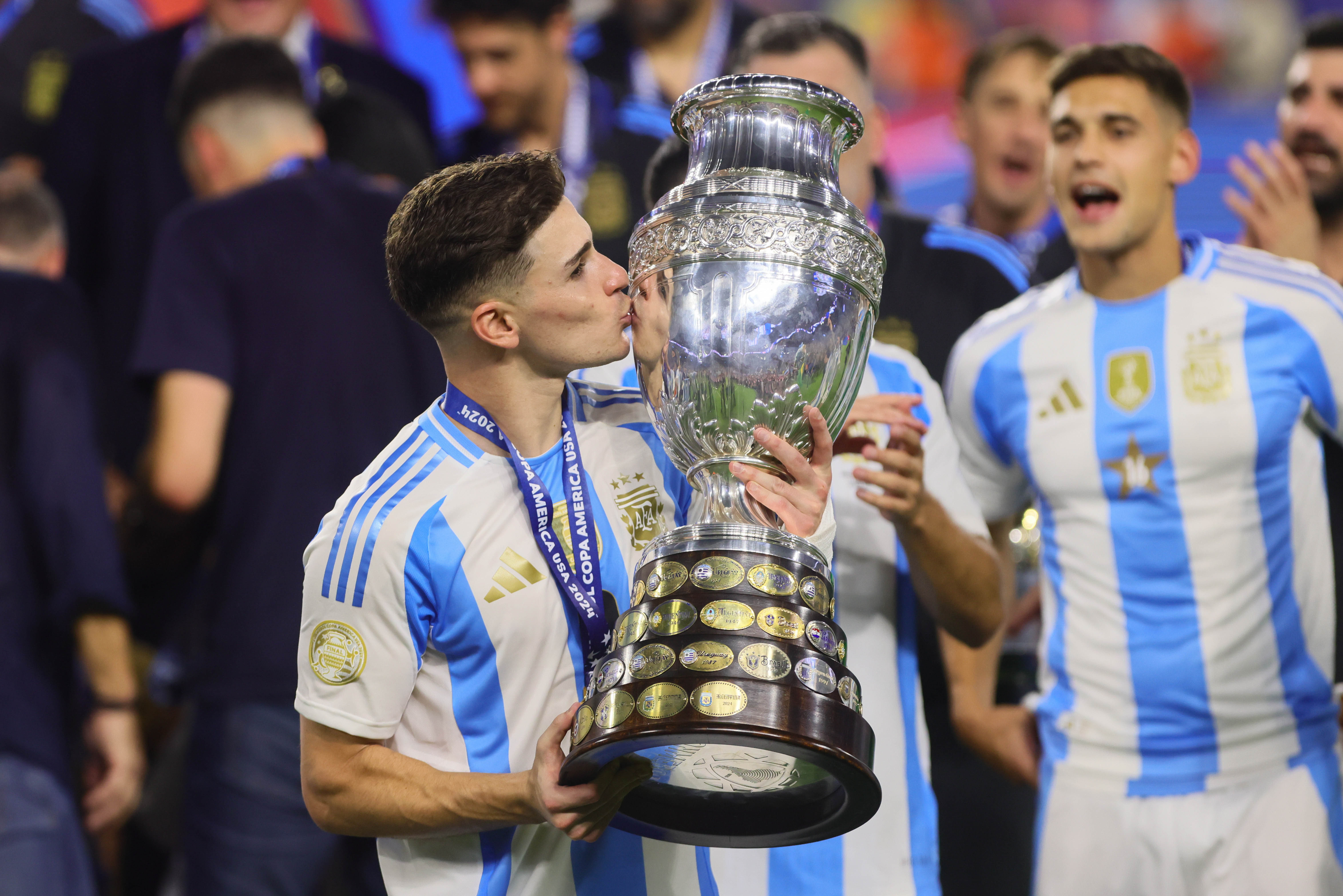 Jul 14, 2024; Miami, FL, USA; Argentina forward Julian Alvarez (9) kisses the trophy after the Copa America final against Colombia at Hard Rock Stadium. Mandatory Credit: Sam Navarro-USA TODAY Sports