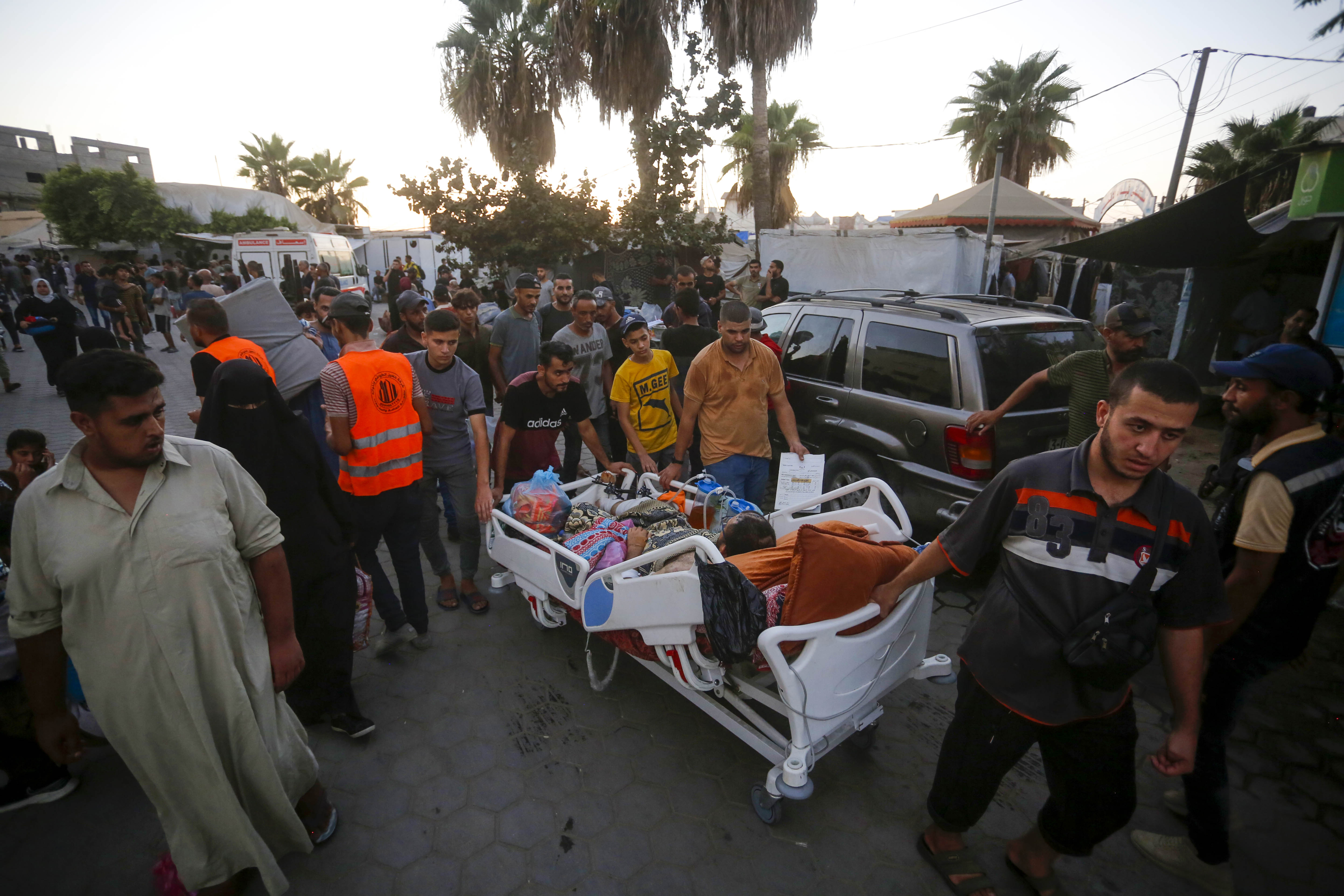 Palestinians evacuate patients from Al Aqsa Martyrs Hospital after the Israeli army demanded Palestinians evacuate an area east of Deir al-Balah