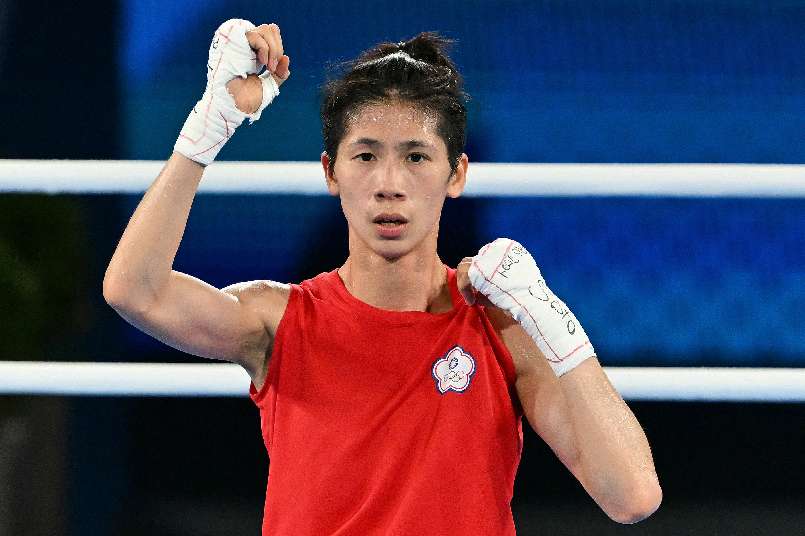 Taiwan's Lin Yu-ting reacts after beating Poland's Julia Szeremeta (Blue) in the women's 57kg final boxing match during the Paris 2024 Olympic Games at the Roland-Garros Stadium, in Paris on August 10, 2024. (Photo by MOHD RASFAN / AFP)