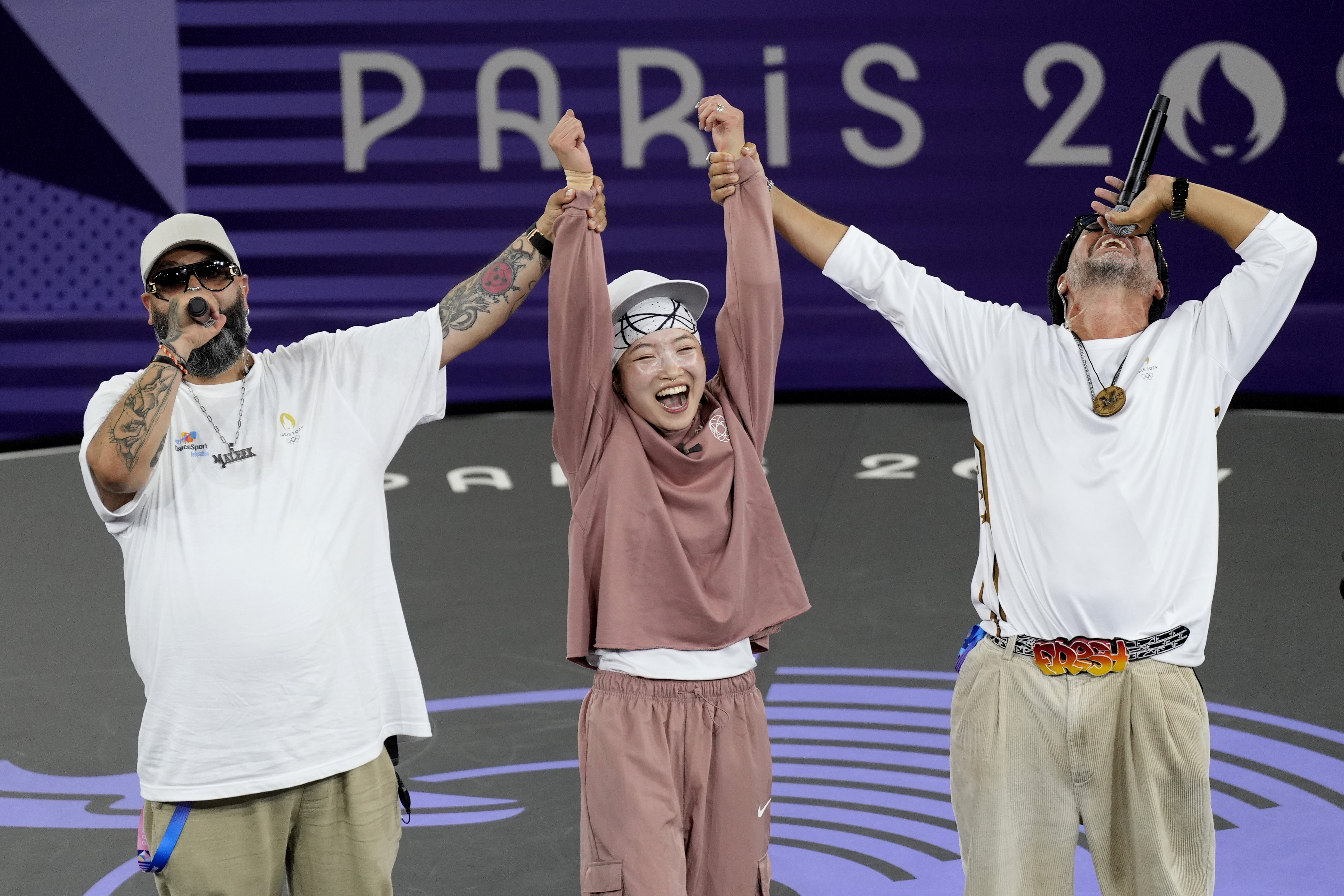 Japan's Ami Yuasa, known as B-Girl Ami, celebrates after winning the gold medal during the B-Girls gold medal battle at the breaking competition at La Concorde Urban Park at the 2024 Summer Olympics, Friday, Aug. 9, 2024, in Paris, France. (AP Photo/Abbie Parr)