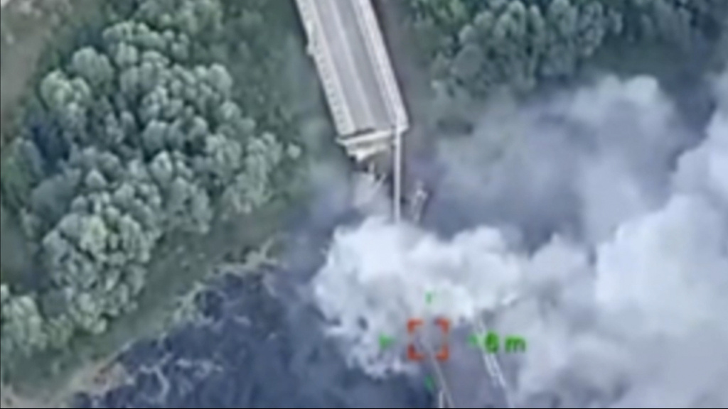 Aerial photo shows plume of smoke over a bridge