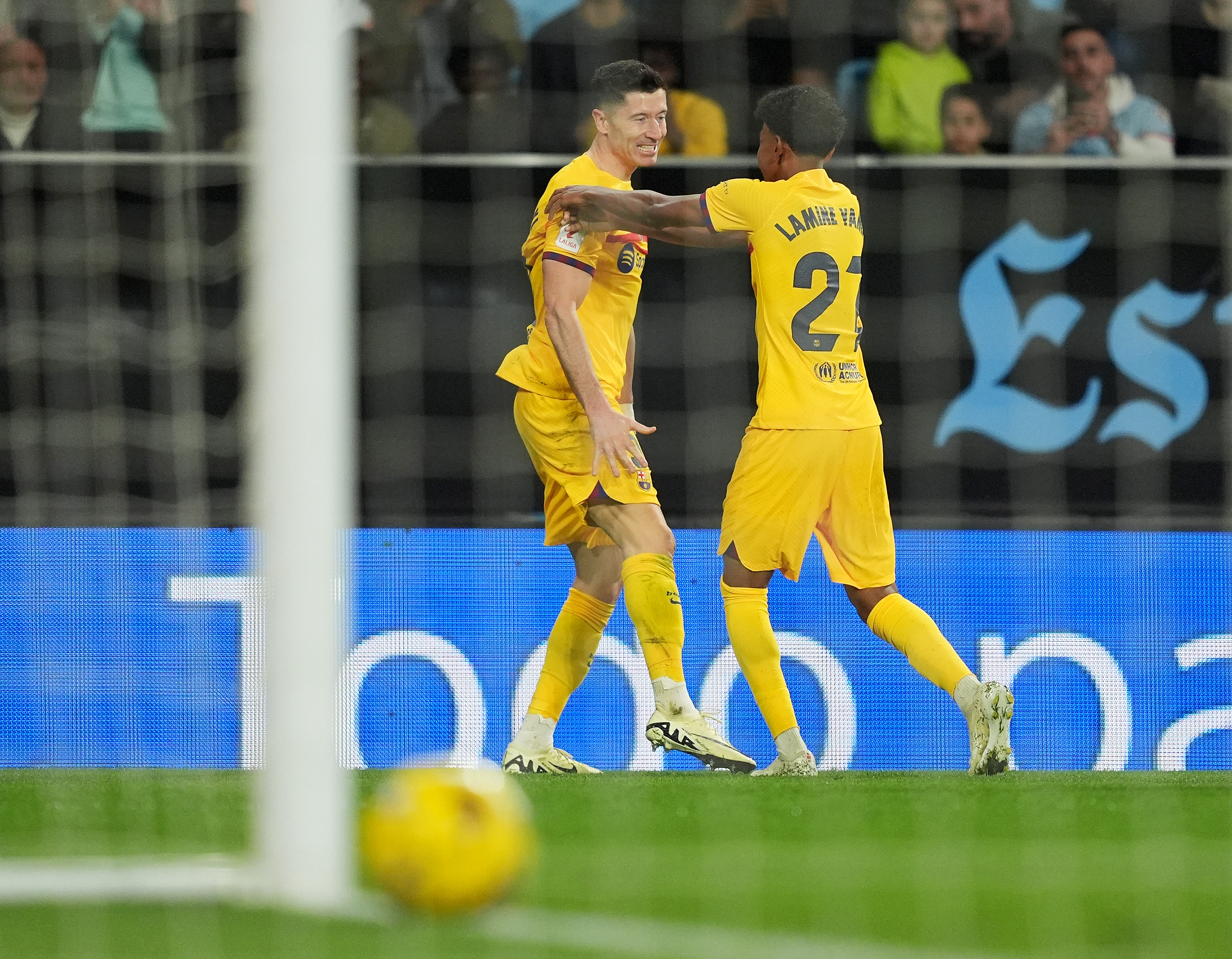 VIGO, SPAIN - FEBRUARY 17: Robert Lewandowski of FC Barcelona celebrates scoring his team's first goal with teammate Lamine Yamal during the LaLiga EA Sports match between Celta Vigo and FC Barcelona at Estadio Balaidos on February 17, 2024 in Vigo, Spain. (Photo by Juan Manuel Serrano Arce/Getty Images)