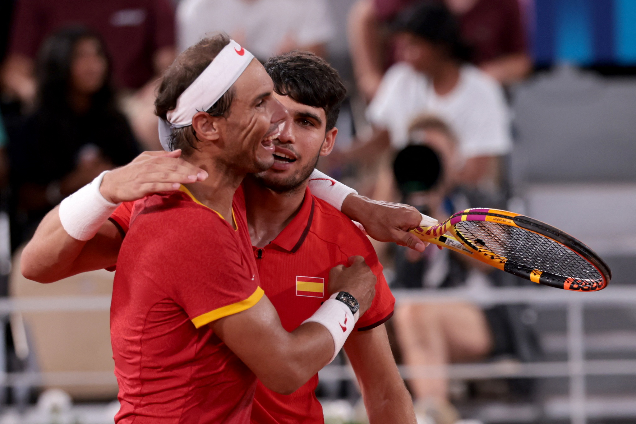 Paris 2024 Olympics - Tennis - Men's Doubles Quarterfinals - Roland-Garros Stadium, Paris, France - July 31, 2024. Carlos Alcaraz of Spain and Rafael Nadal of Spain react after losing their match against Austin Krajicek of United States and Rajeev Ram of United States. REUTERS/Claudia Greco