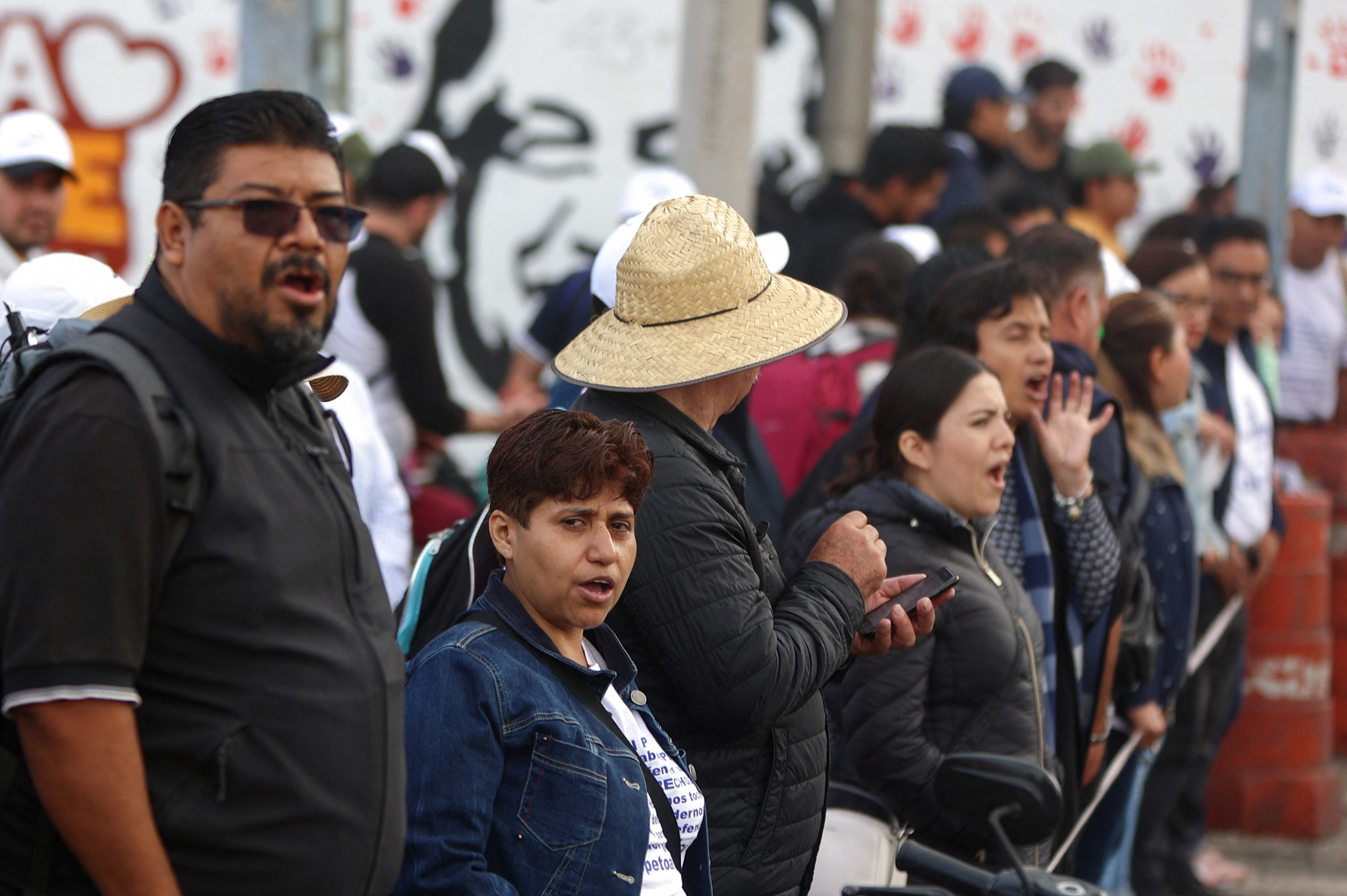 demonstrators form a line on a Mexico City street.