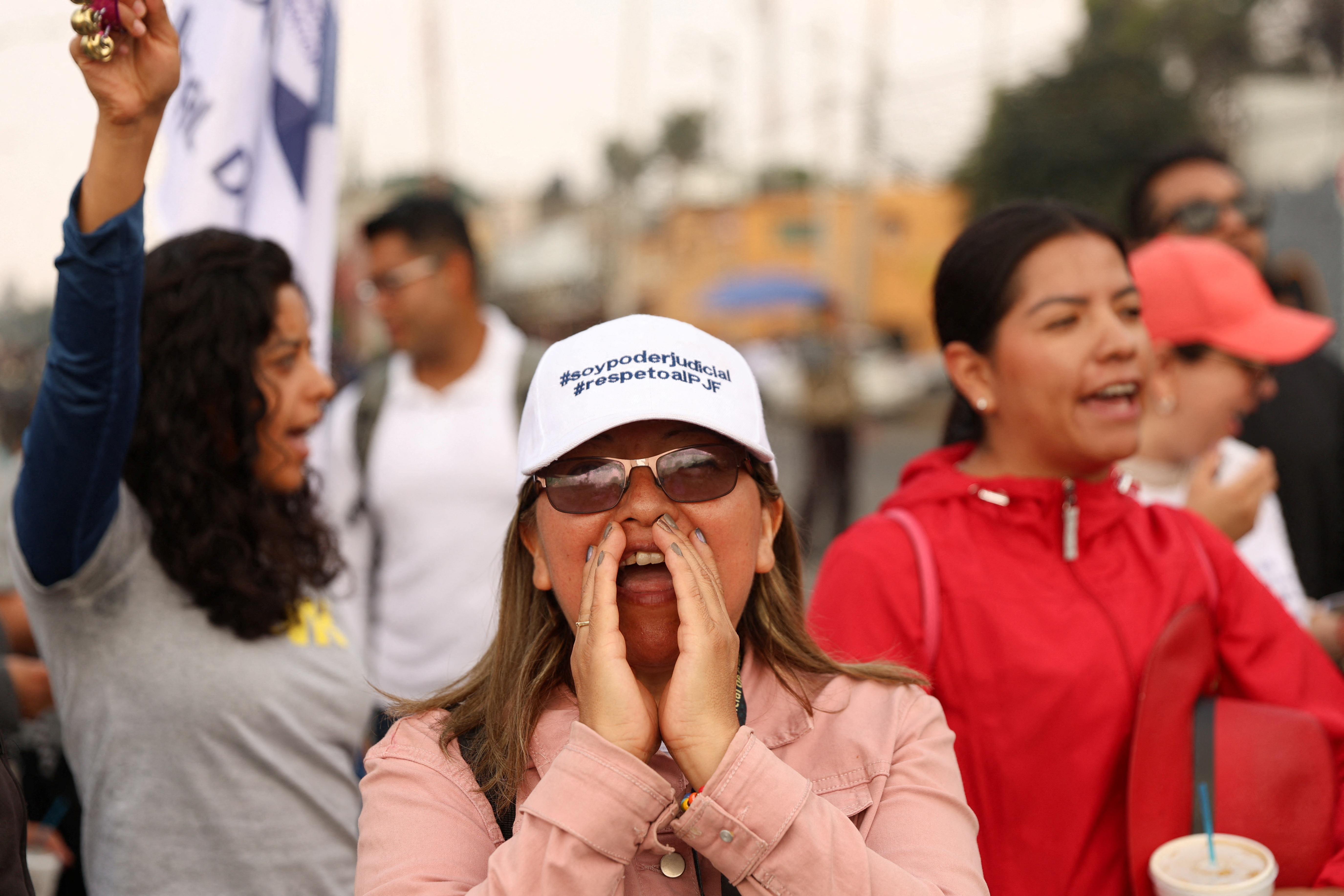A woman shouts through her hands at a Mexico City protest