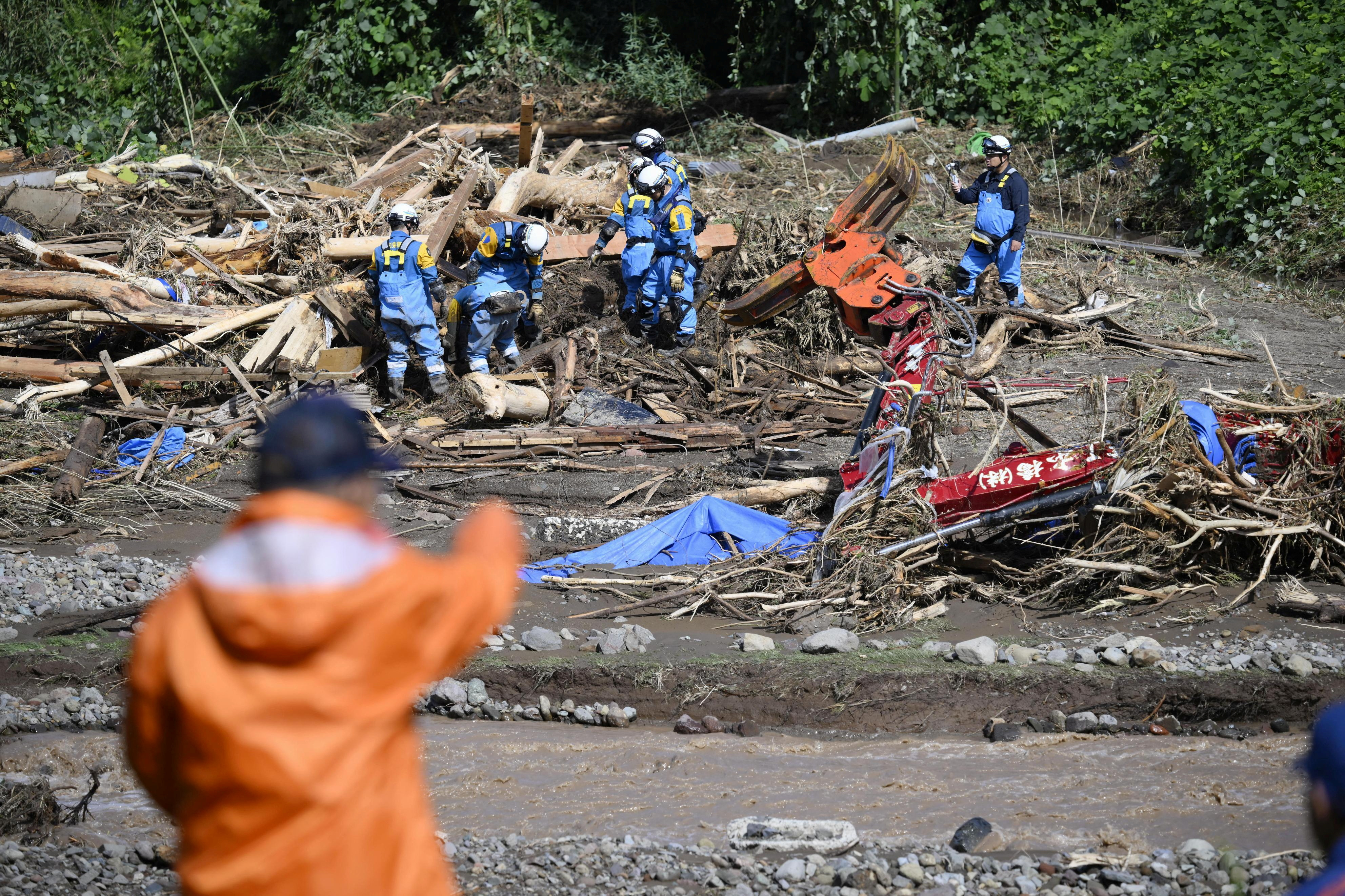 Rescuers comb muddy riverbanks after Japan floods kill six