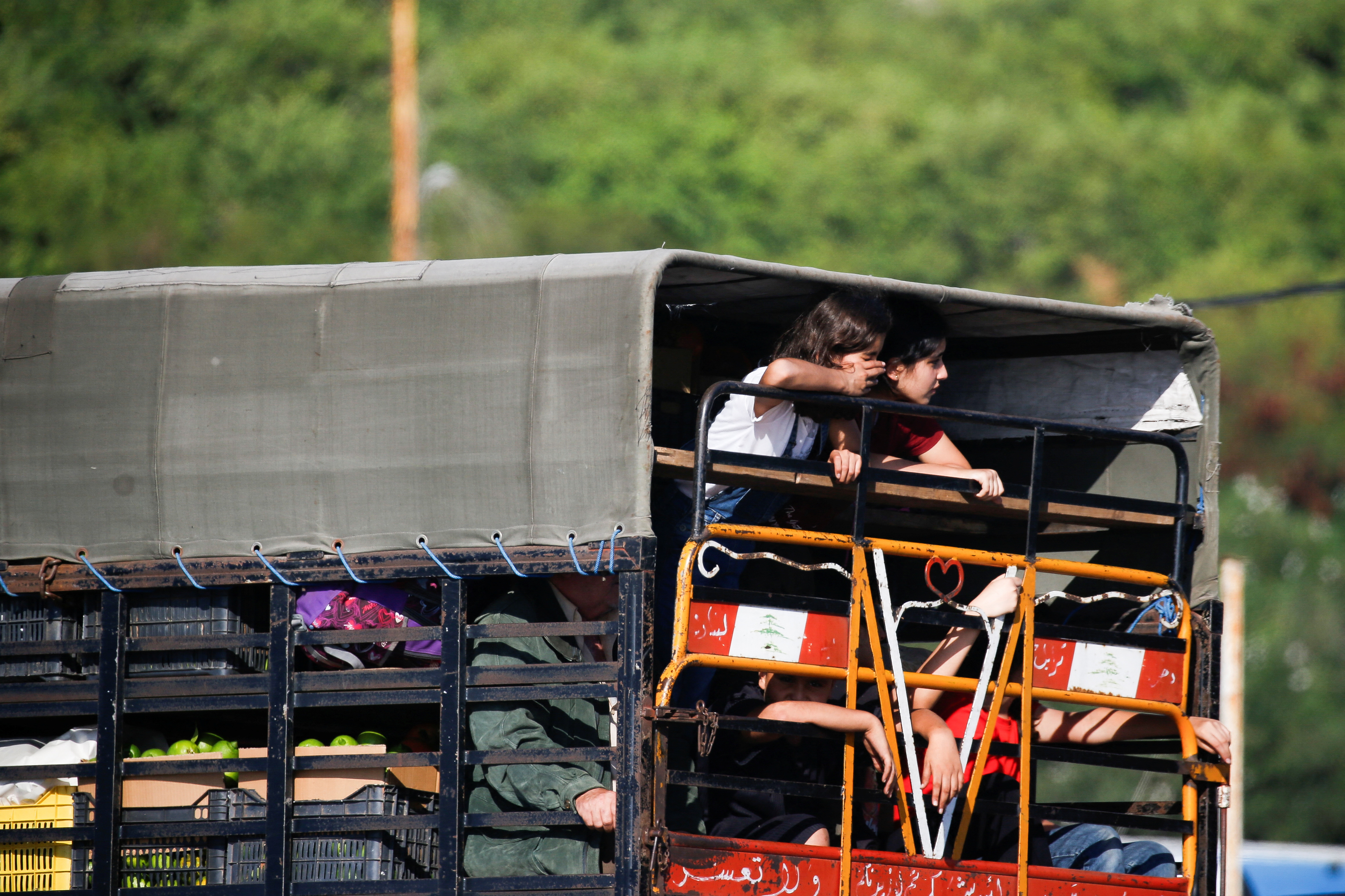 People in heavy traffic drive north from Lebanon's southern coastal city Sidon