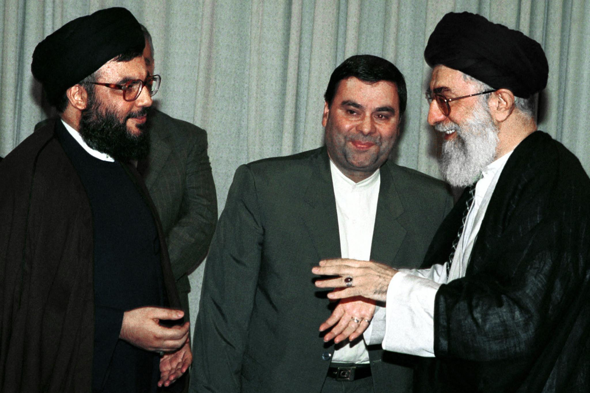 (FILES) Iran's supreme leader Ayatollah Ali Khamenei welcomes Hezbollah Secretary General Sheikh Hassan Nasrallah (L) at his office in Tehran 04 July 2000. Backed by Iran and hated by Israel, Nasrallah is Lebanon's most powerful man. Even though he has rarely been seen publicly since the 2006 war with Israel, Nasrallah enjoys cult status among his Shiite supporters, is equipped with a formidable arsenal far bigger and more modern than the national army's, and holds sway over the country's institutions. (Photo by AFP)