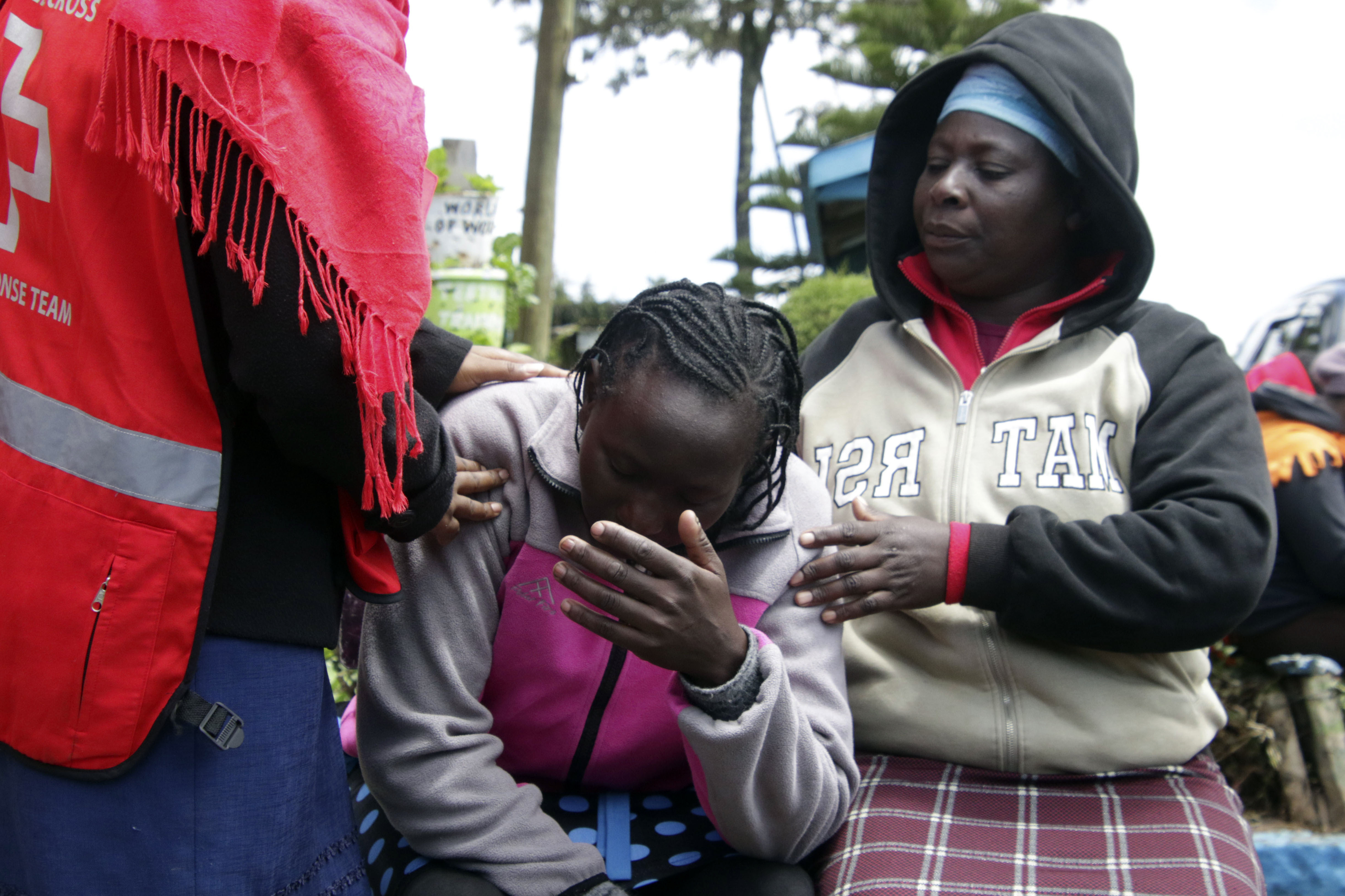 A woman cries near burned dormitory