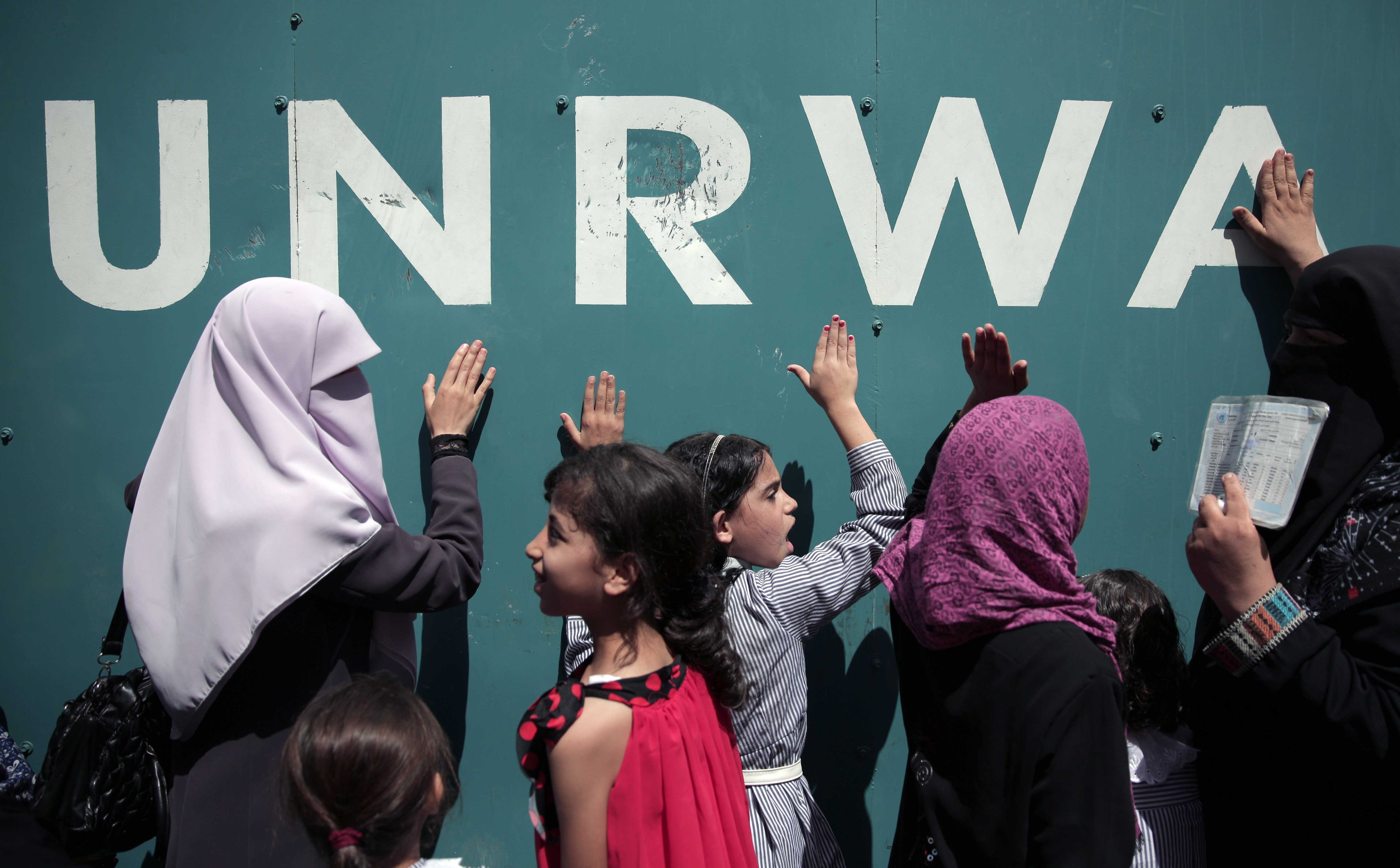 Palestinians at UNRWA’s Gaza headquarters in Gaza City. The agency runs schools and provides healthcare and social services to Palestinian refugees