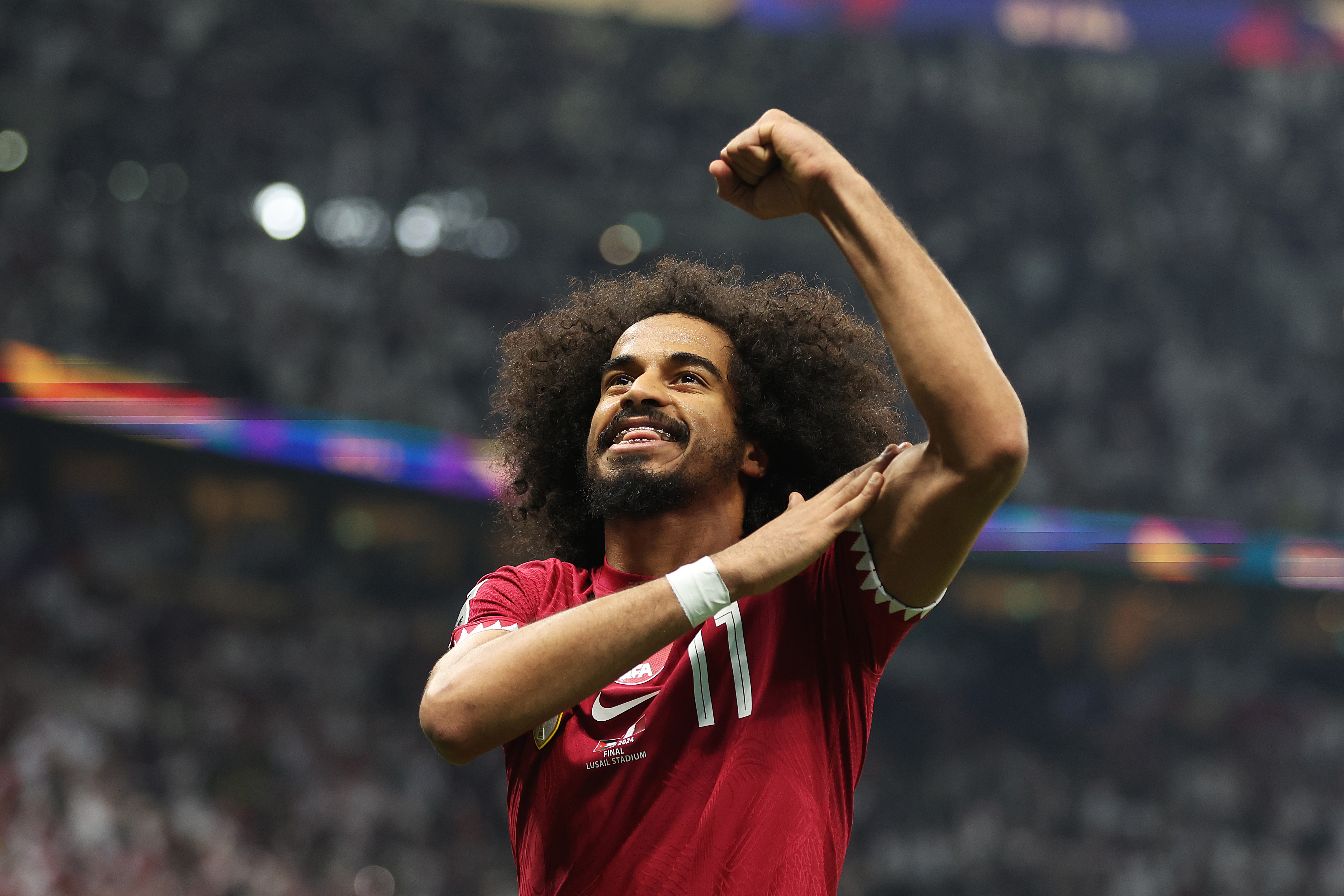LUSAIL CITY, QATAR - FEBRUARY 10: Akram Afif of Qatar celebrates scoring his team's second goal from the penalty spot during the AFC Asian Cup final match between Jordan and Qatar at Lusail Stadium on February 10, 2024 in Lusail City, Qatar. (Photo by Robert Cianflone/Getty Images)