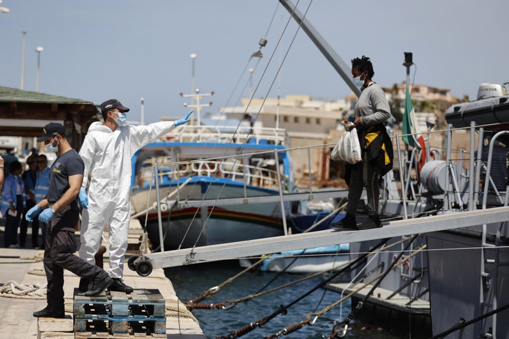 Migrants arrive at the harbor of the Sicilian island of Lampedusa