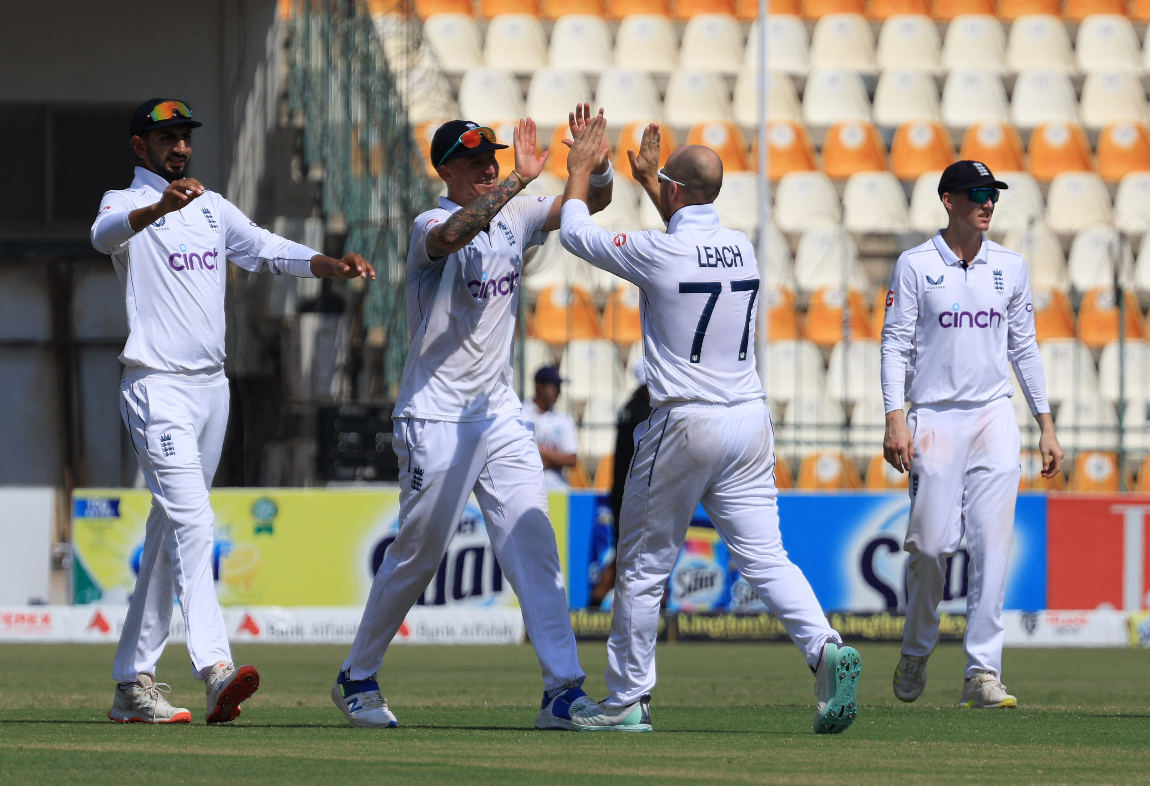 Cricket - First Test - England v Pakistan - Multan Cricket Stadium, Multan, Pakistan - October 11, 2024 England's Jack Leach and Brydon Carse celebrate after winning the test REUTERS/Akhtar Soomro