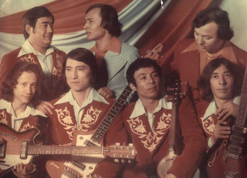 Uighur band Yashlik, whose founder Murat Akhmadiev (top row, centre, in grey suit) came from Xinjiang in western China before moving to Kazakhstan and recording in Uzbekistan