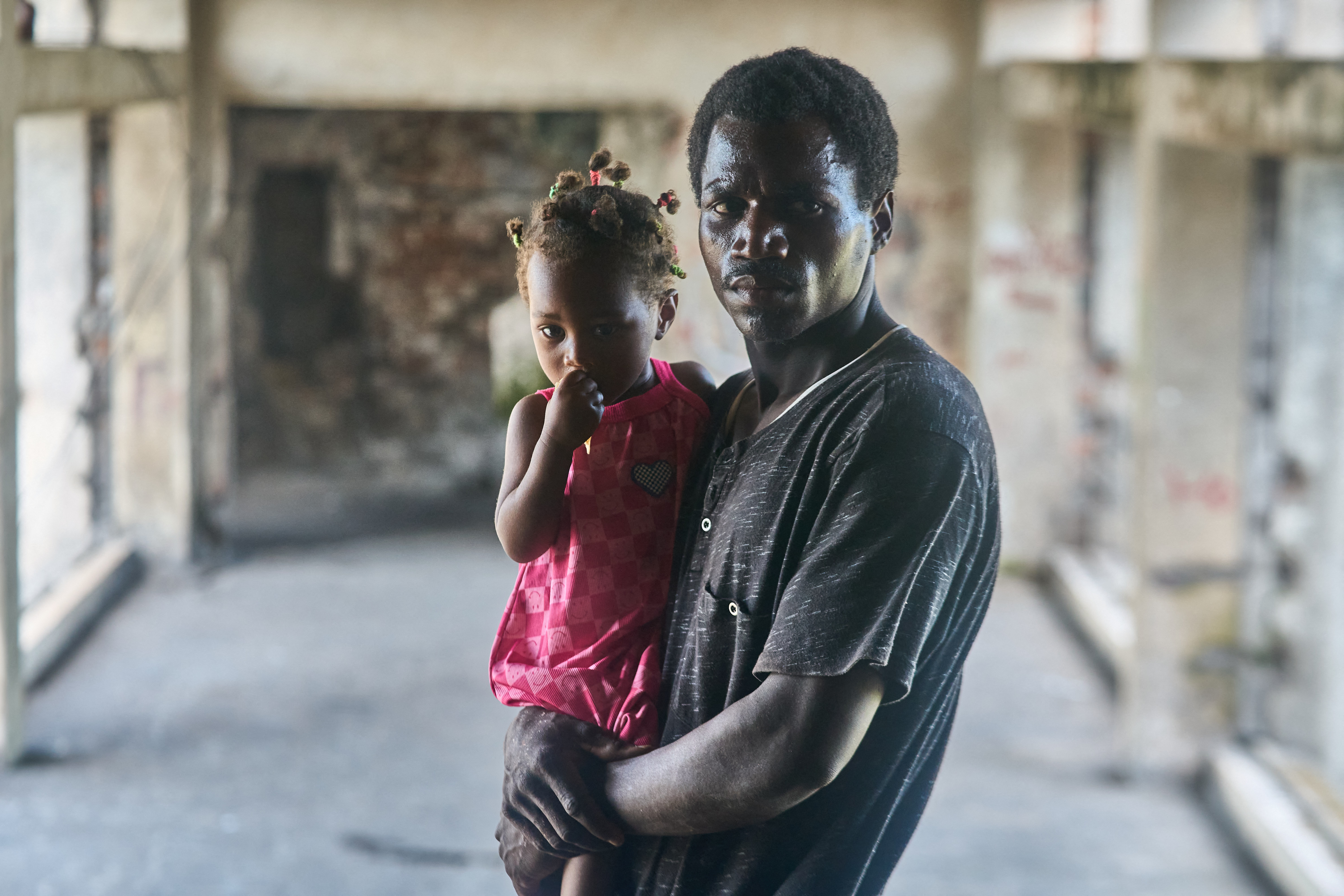 Fernando Jose, 37, poses for a photo with his daughter in the Grande Hotel in Beira on October 12