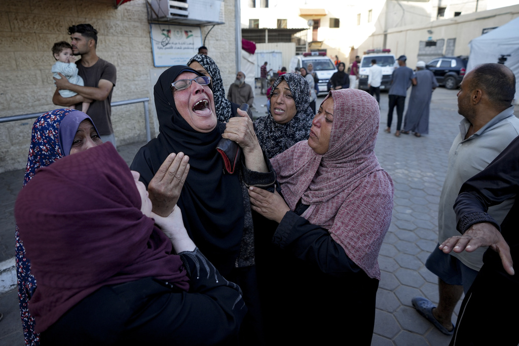 Palestinians mourn relatives killed in the Israeli bombardment of the Gaza Strip at a hospital morgue in Deir al-Balah, on October 2, 2024. (AP Photo/Abdel Kareem Hana)