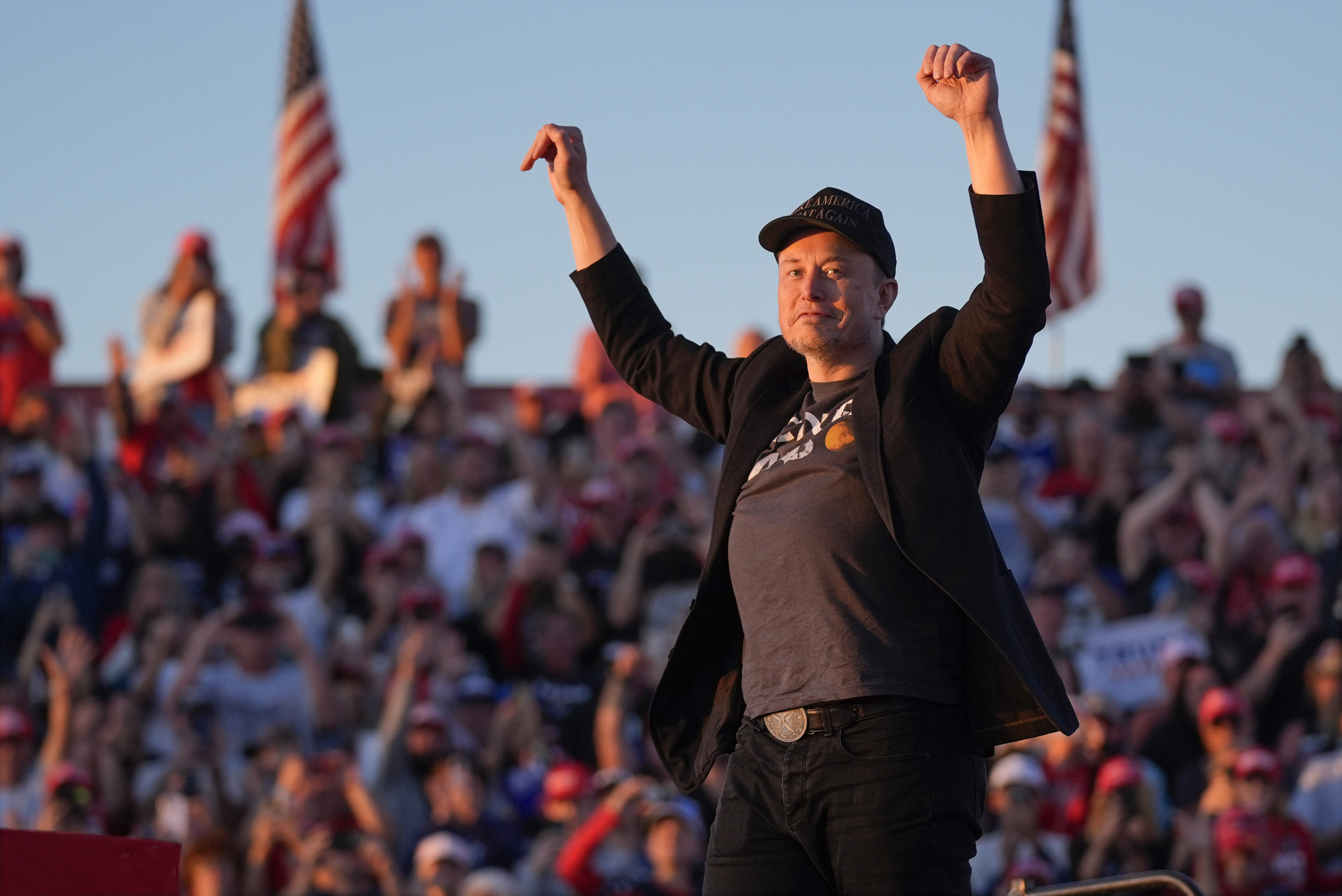 Elon Musk arrives on the stage as Republican presidential nominee former President Donald Trump speaks at a campaign rally at the Butler Farm Show, Saturday, Oct. 5, 2024.