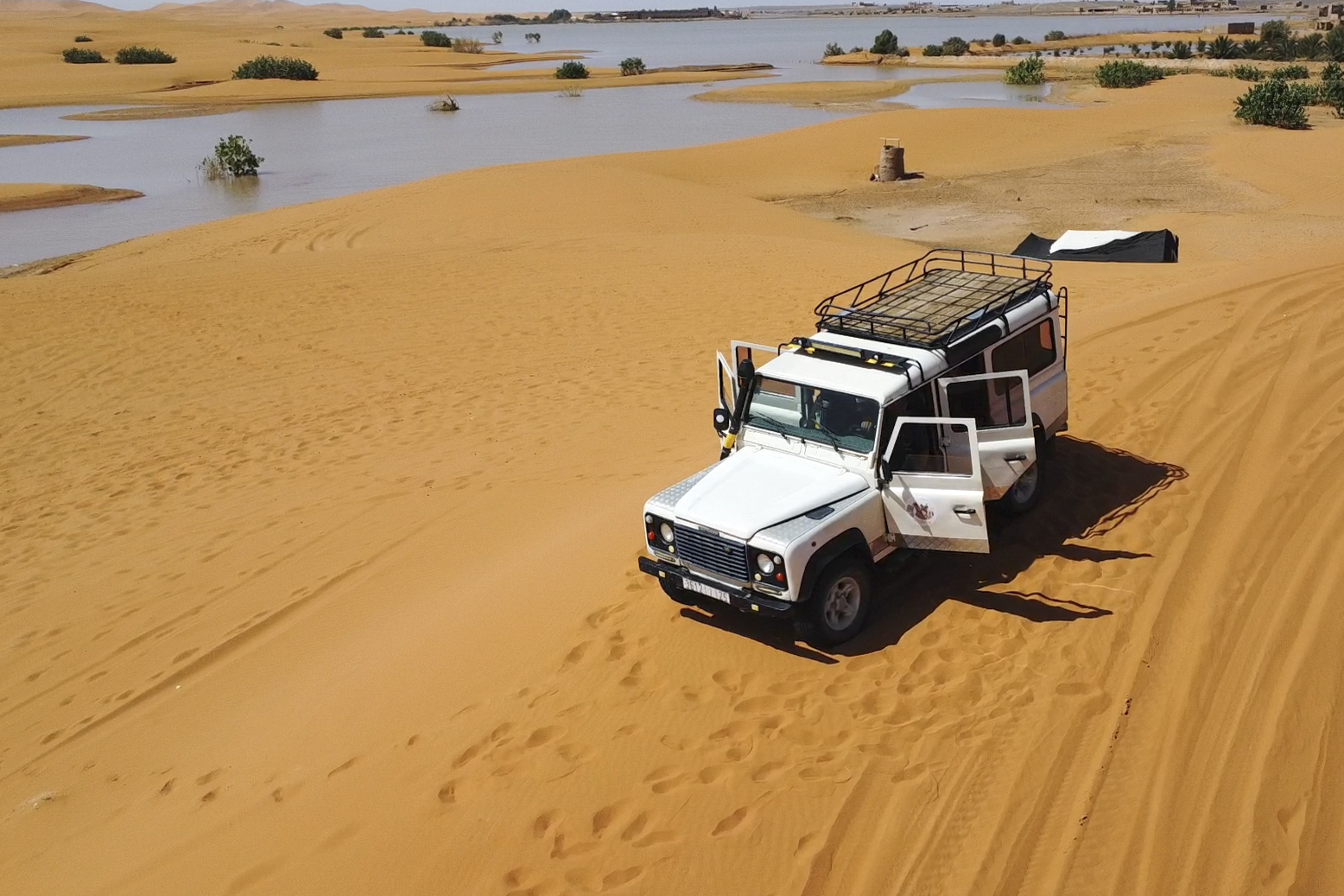 Palm trees are flooded in a lake caused by heavy rainfall in the desert town of Merzouga