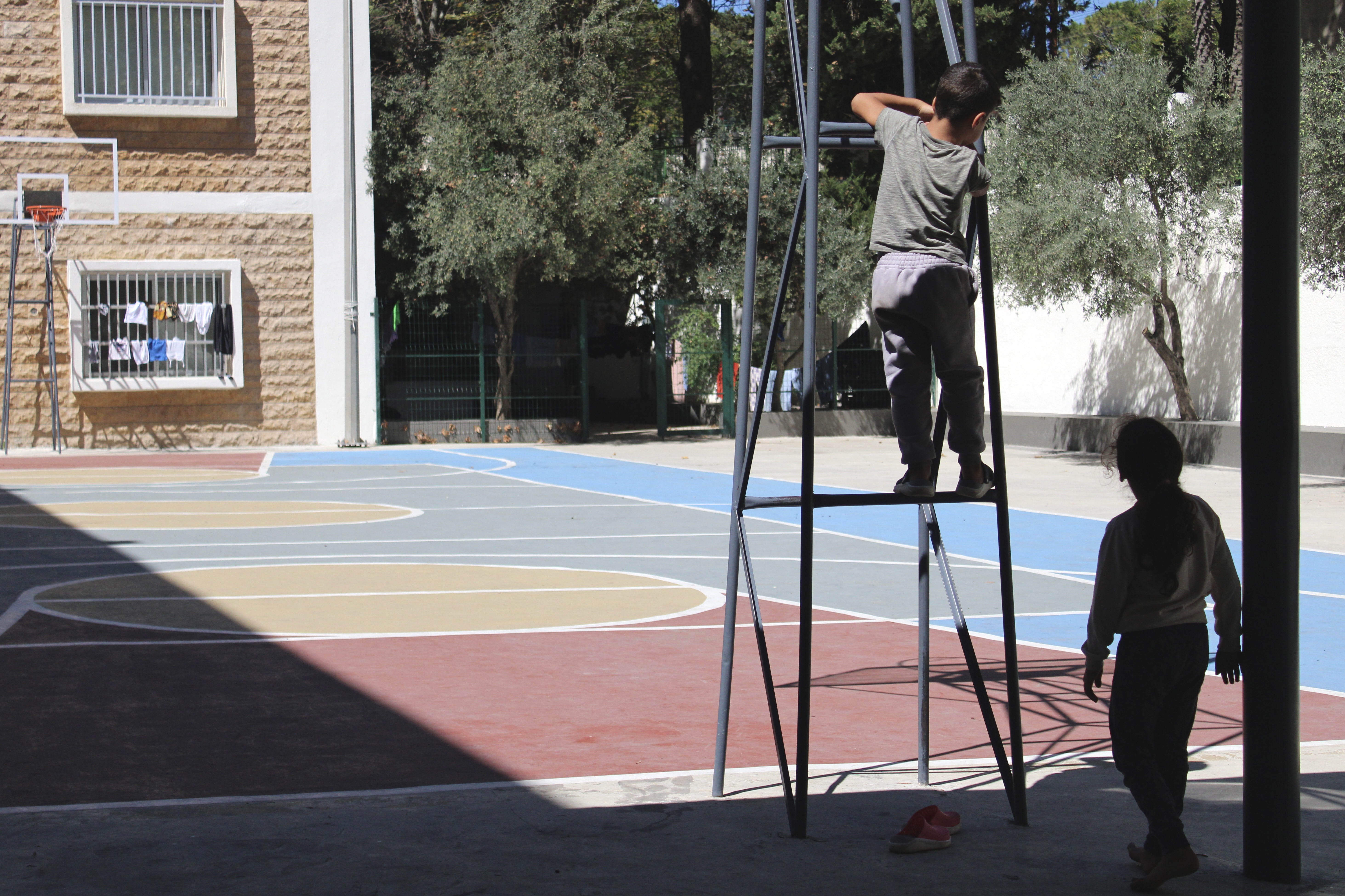 Children, who have taken refuge at Khalid Jumblatt Public School in Aley with their families, play in the grounds of the school
