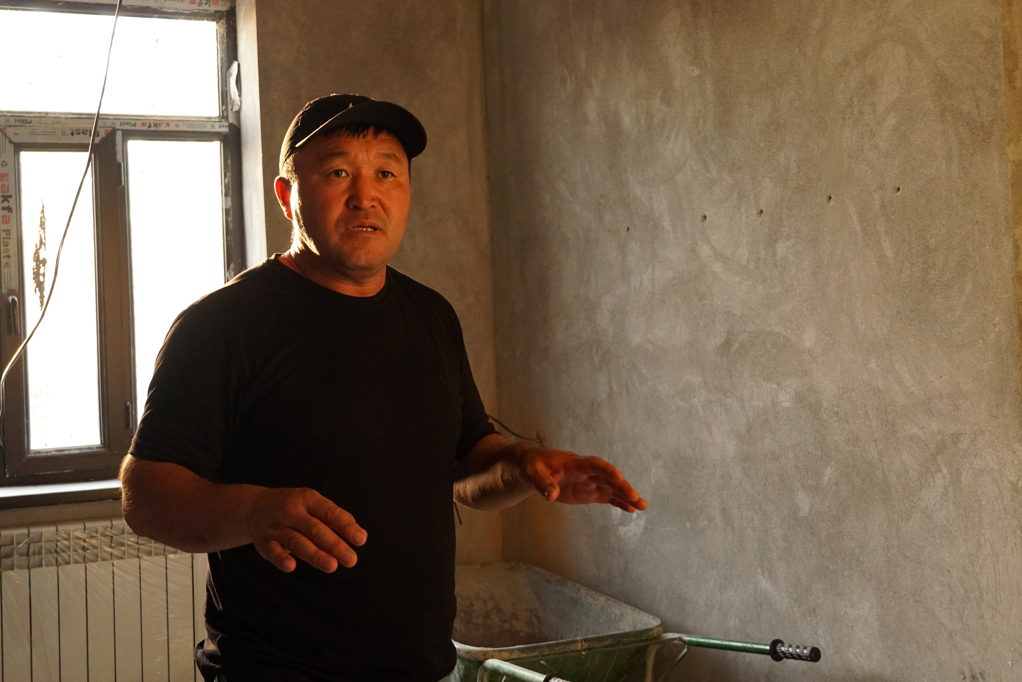 Talantbek recalls how Mediyana wanted to become a dentist from a young age as he stands in the dining room of the new family home he is building [Aidai Tokoeva and Savia Hasanova]