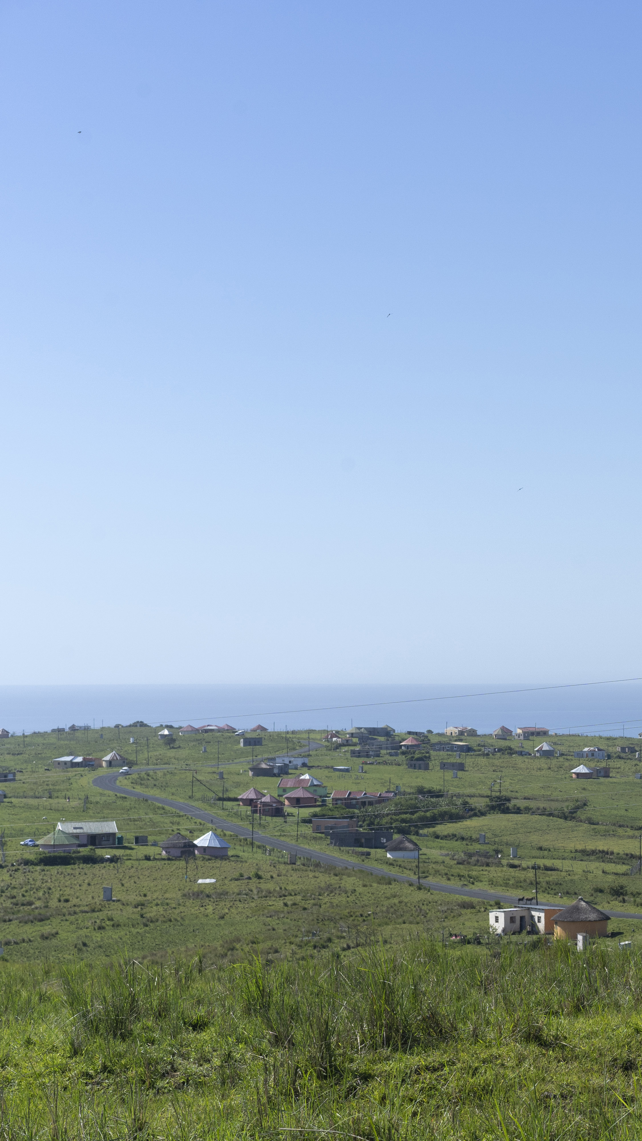 The lush green hills of Hobeni with the Indian Ocean in the background [Barry Christianson/Al Jazeera]