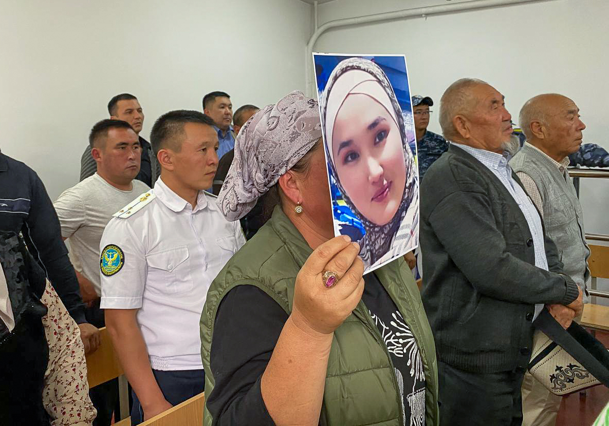 Mediyana’s relative holds a photo of Mediyana at the court in Osh when Abdulbasit was sentenced to life imprisonment in September 2022