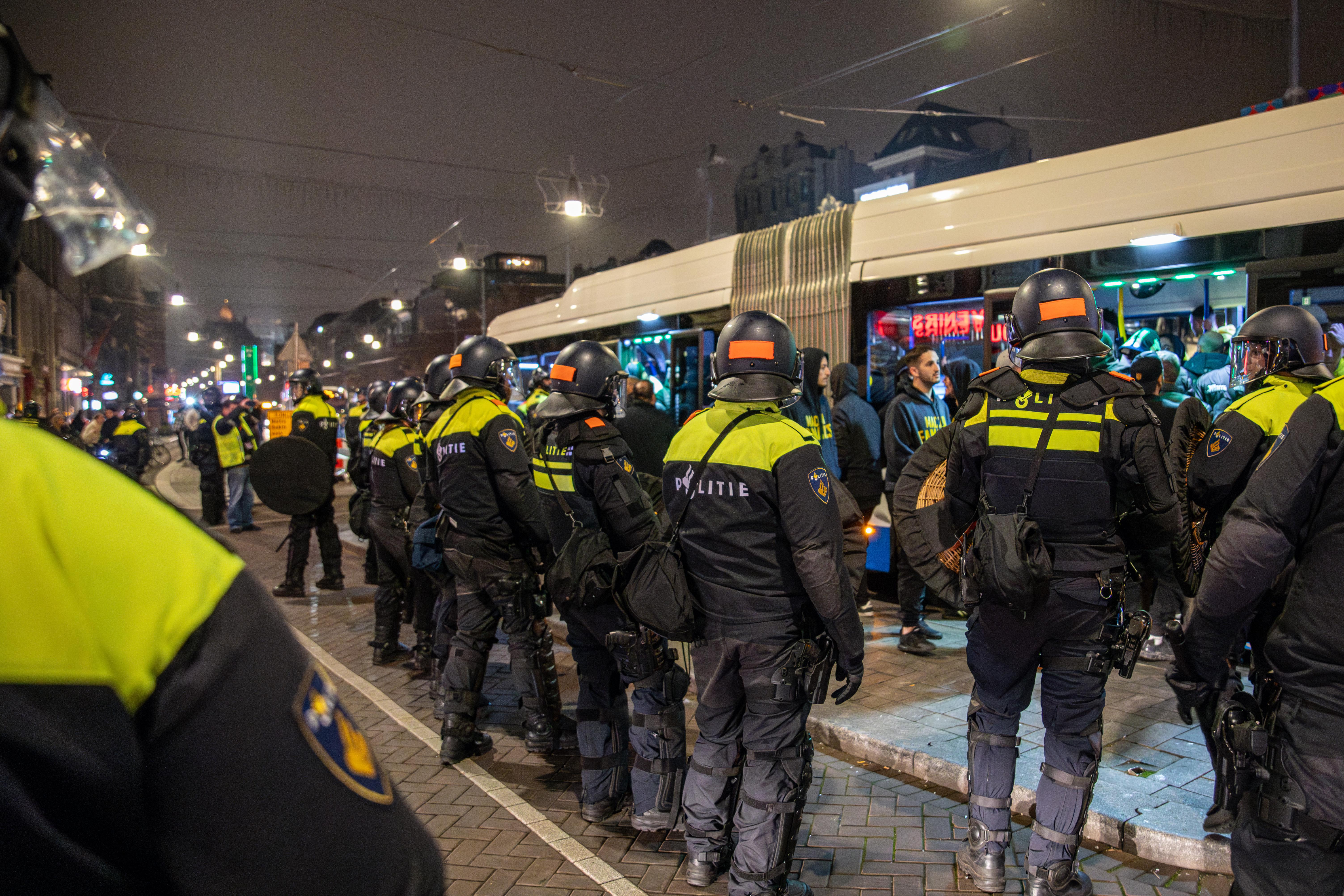 Police officers form a security cordon around a bus after the match in Amsterdam, The Netherlands, on November 8, 2024