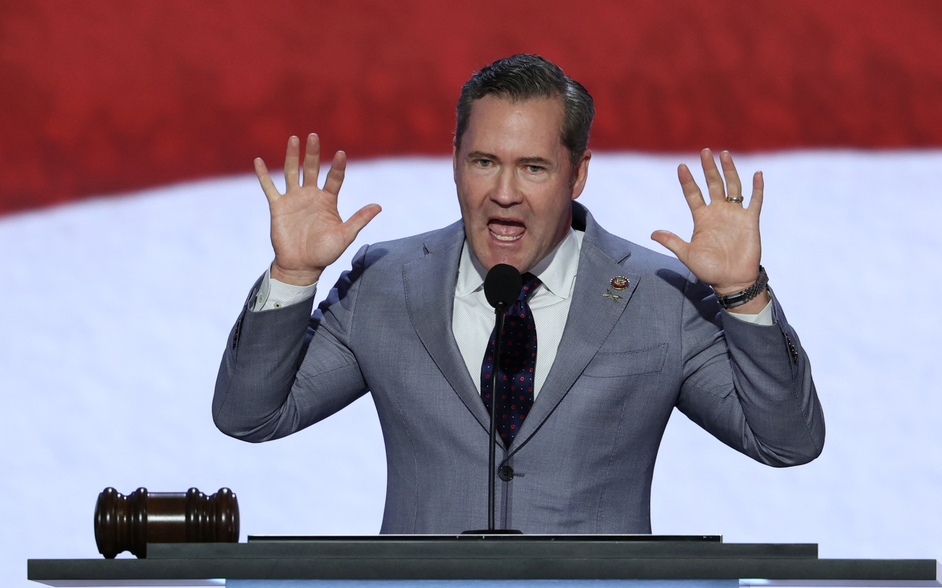 US Congressman Mike Waltz speaks at a microphone