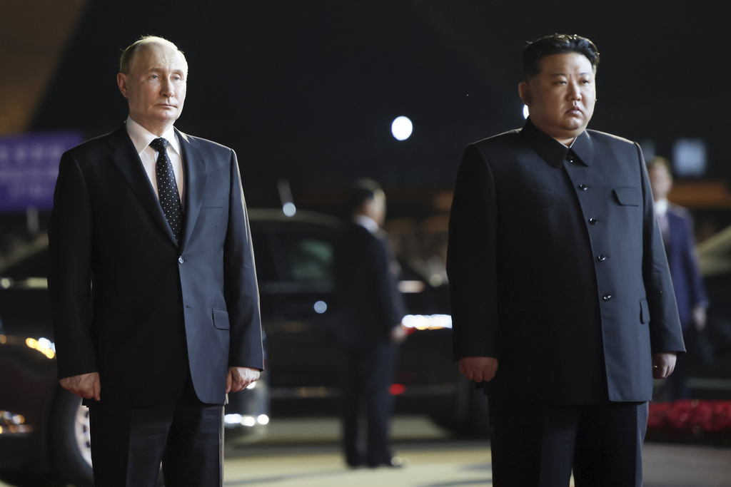 Russian President Vladimir Putin, left, and North Korea's leader Kim Jong Un stand together during the departure ceremony at an international airport outside Pyongyang, North Korea, on Wednesday, June 19, 2024. (Gavriil Grigorov, Sputnik, Kremlin Pool Photo via AP)