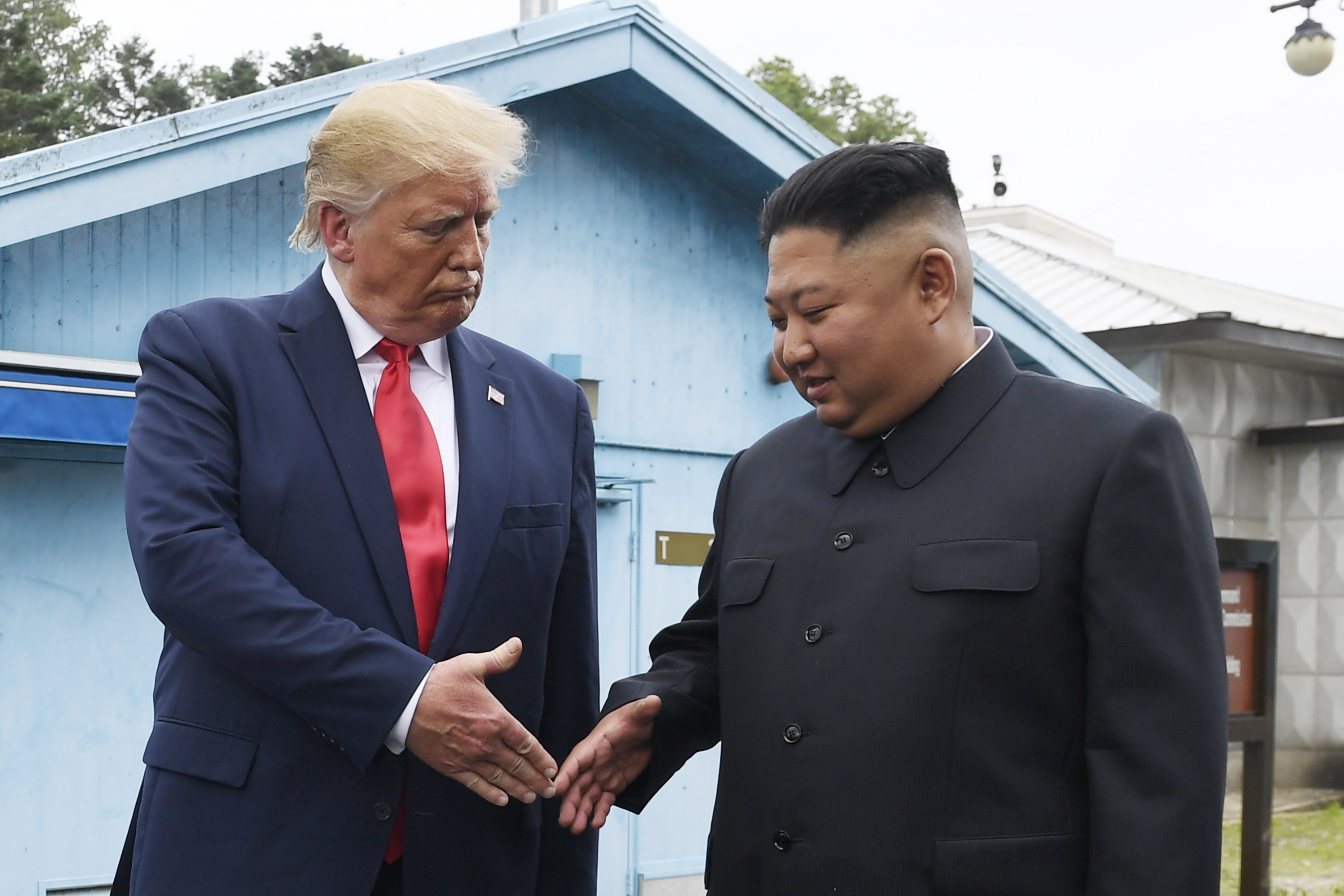 North Korean leader Kim Jong Un, right, and US President Donald Trump prepare to shake hands at the border village of Panmunjom in the Demilitarized Zone, South Korea, during Trump’s first term