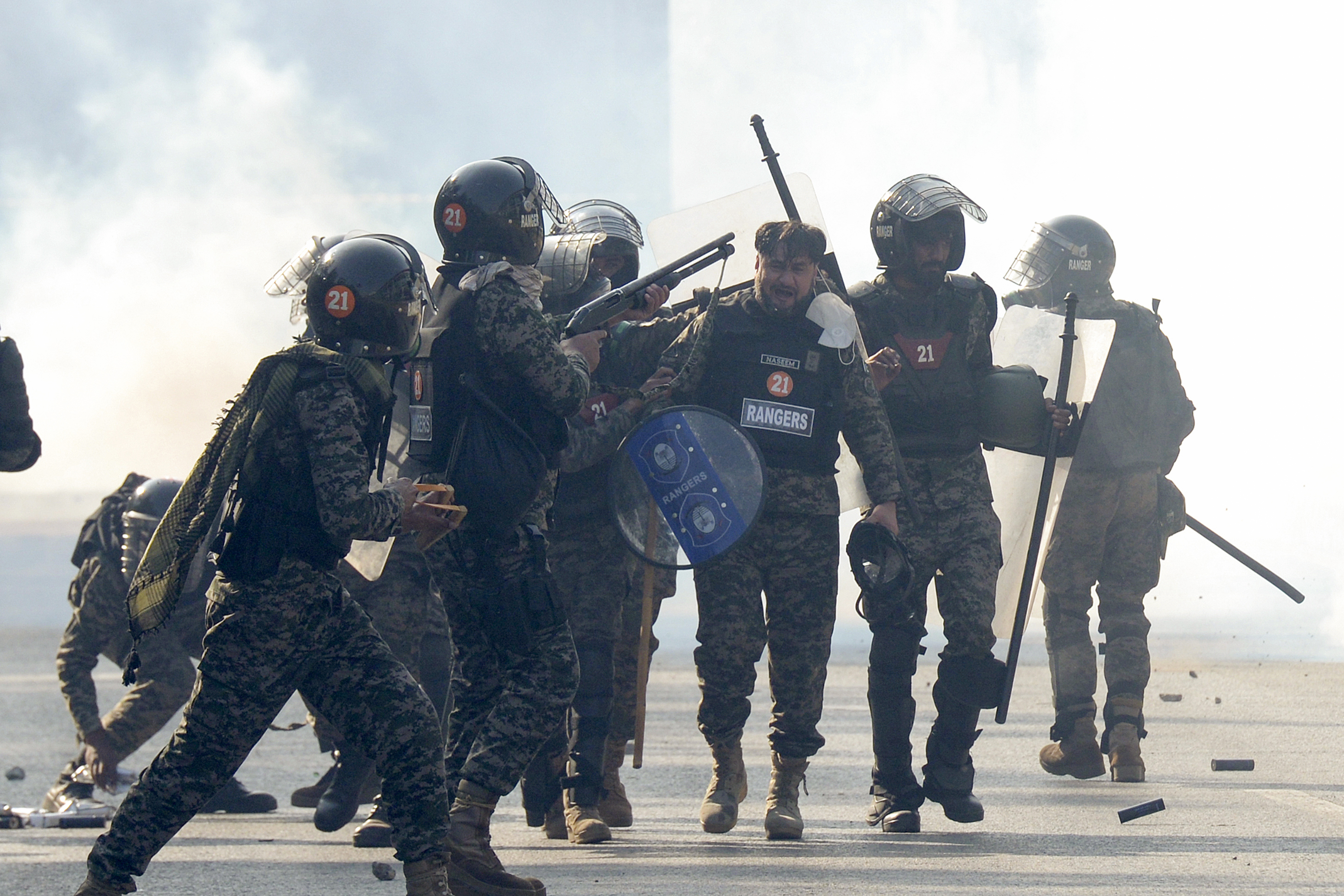Paramilitary soldiers fire rubber bullets to disperse supporters of imprisoned former premier Imran Khan's Pakistan Tehreek-e-Insaf party, during clashes, in Islamabad, Pakistan, Tuesday, Nov. 26, 2024. (AP Photo/Irtisham Ahmed)