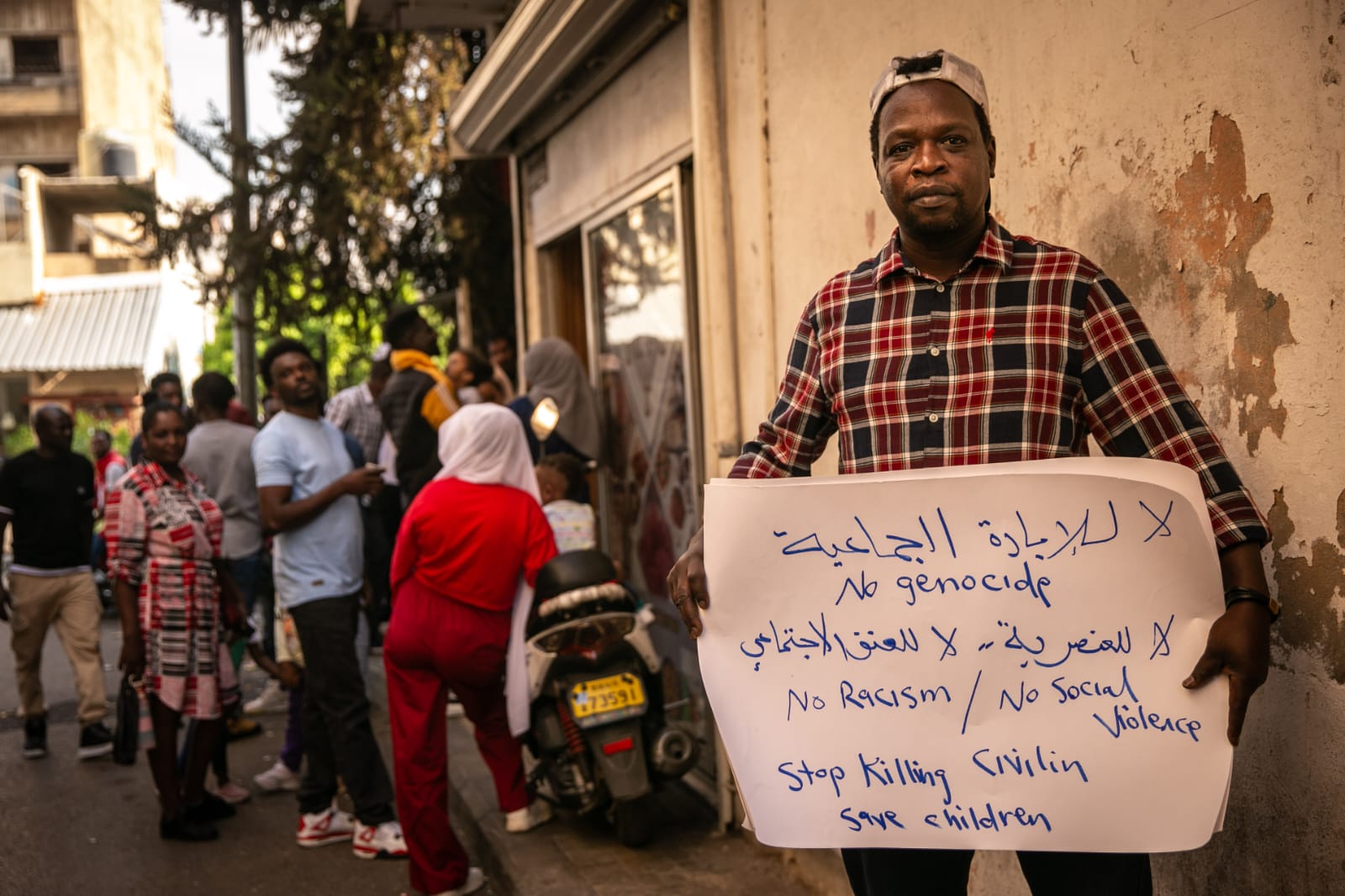 Abdelmonem Yahiya Osman holds a sign at protest in Beirut, Lebanon