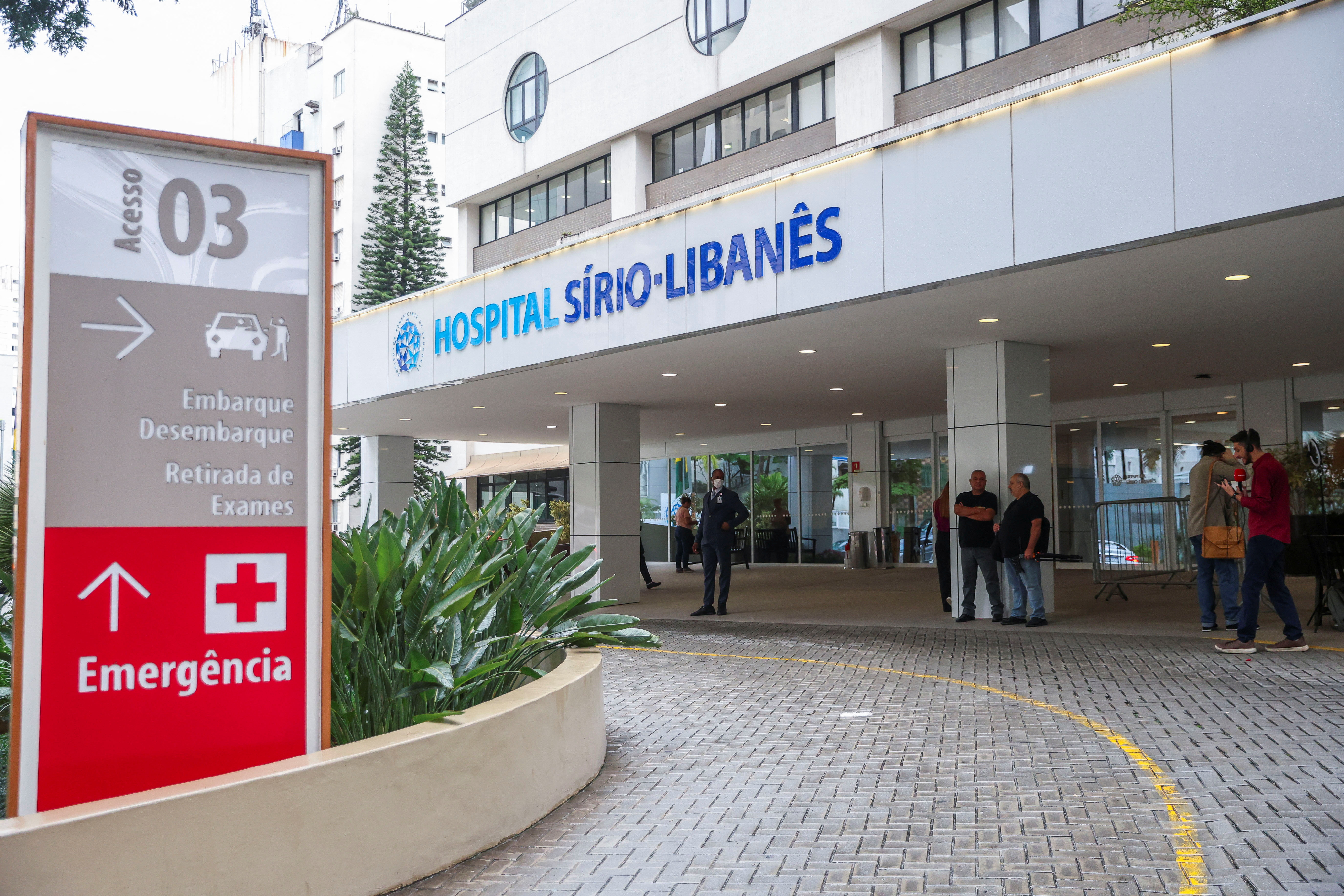 People stand outside the Sirio-Libanes Hospital in Sao Paulo, Brazil, December 10