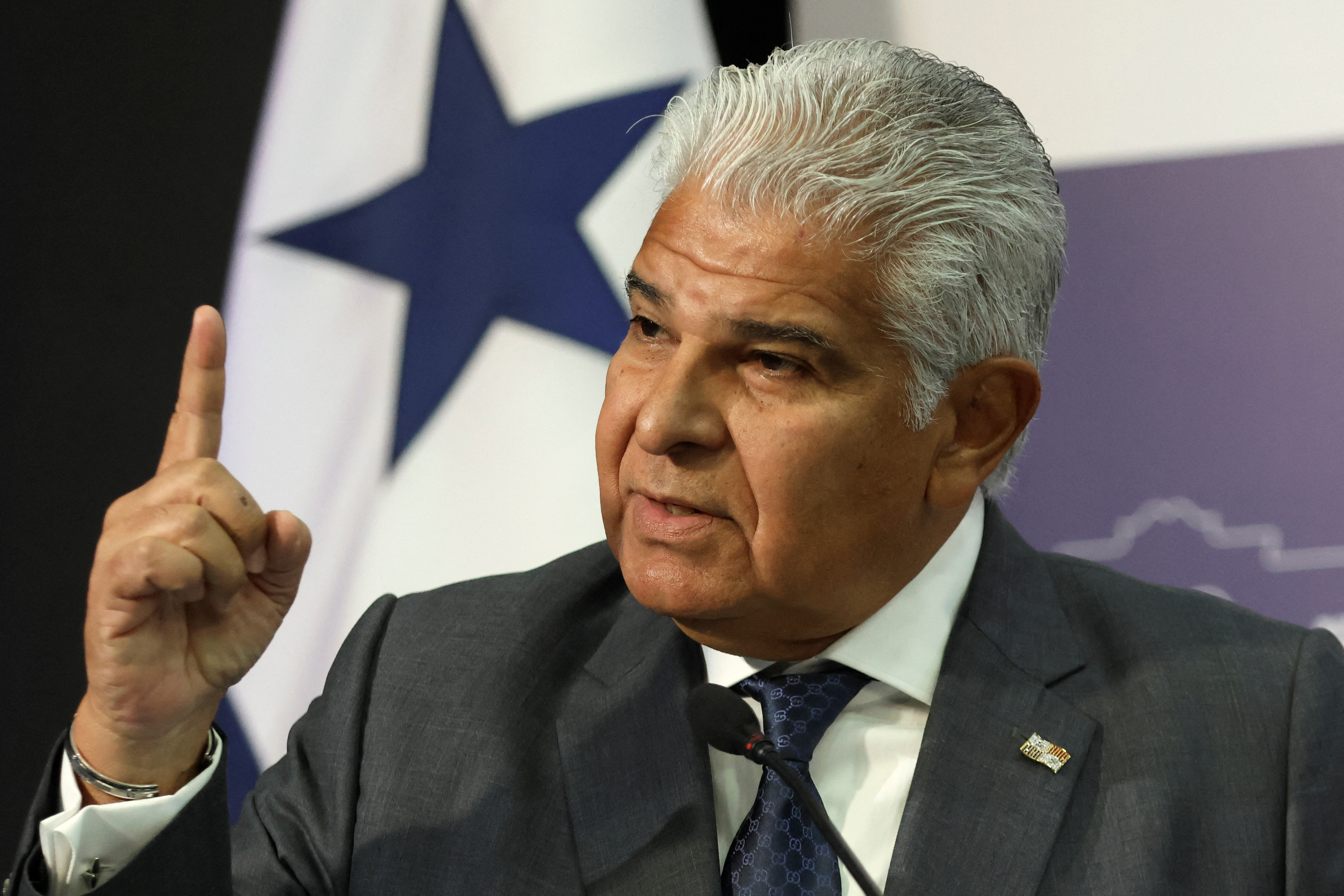 Panama’s President Jose Raul Molino holds up his finger during a news conference