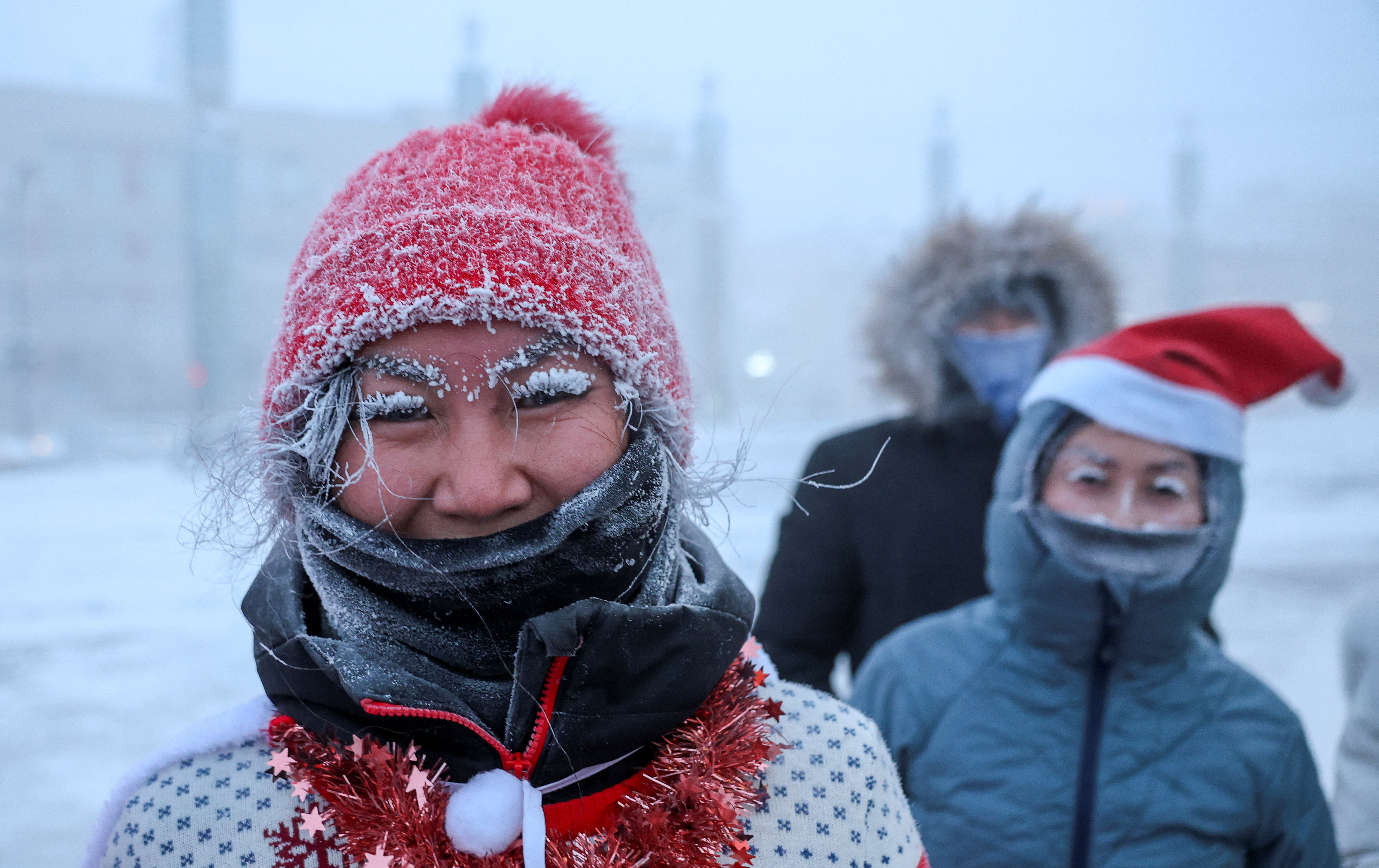 Participants of the New Year's Eve race run gather near a Christmas tree, after the temperature went below minus 47 degrees Celsius (minus 52.6 degrees Fahrenheit) in Yakutsk, the capital of the Sakha Republic located in the northeastern part of Siberia, Russia, December 31