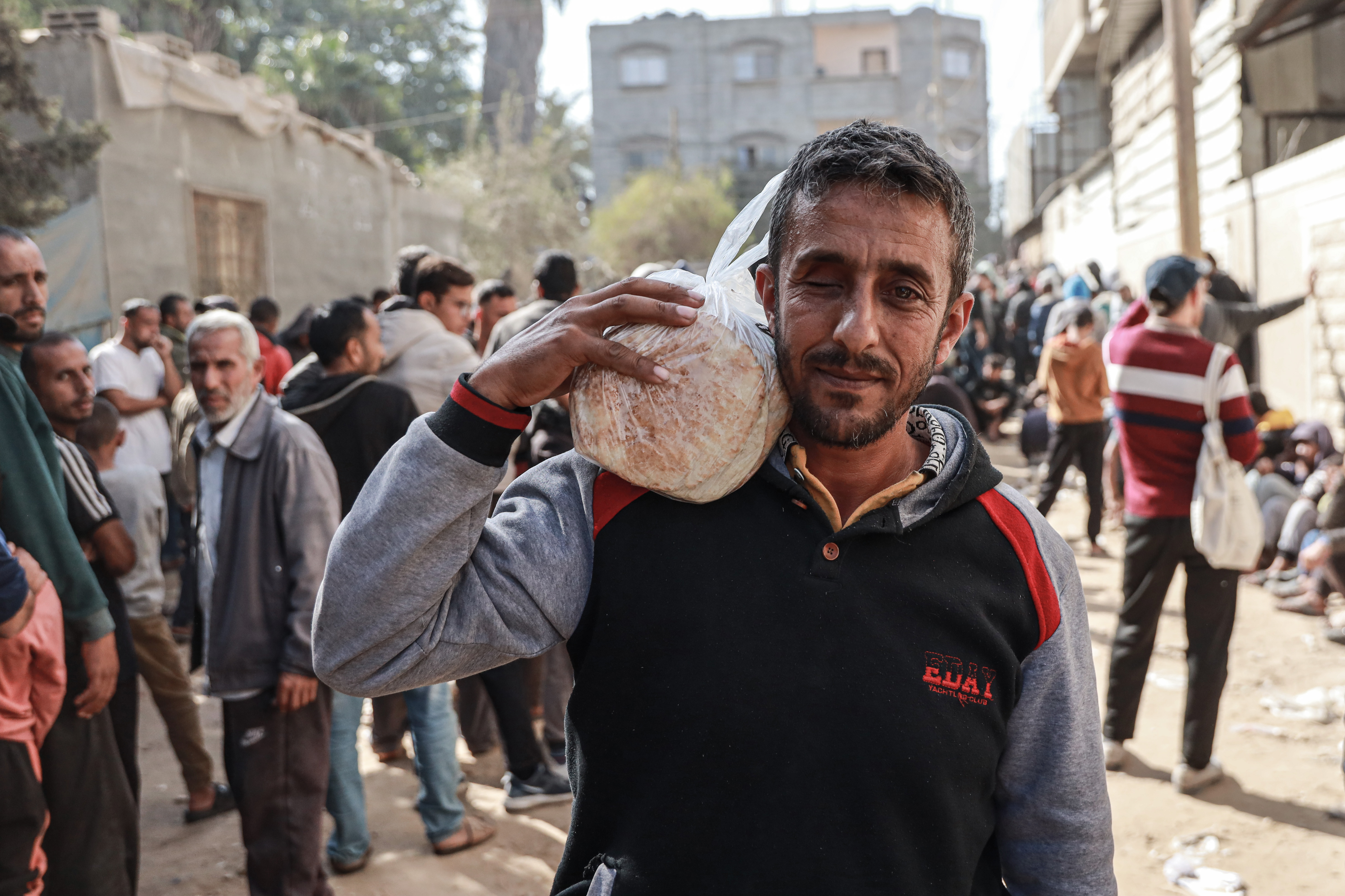 Mohammed Dardouna arrives in early hours of the morning to stand in line at the bakery to get bread [Abdelhakim Abu Riash/Al Jazeera]
