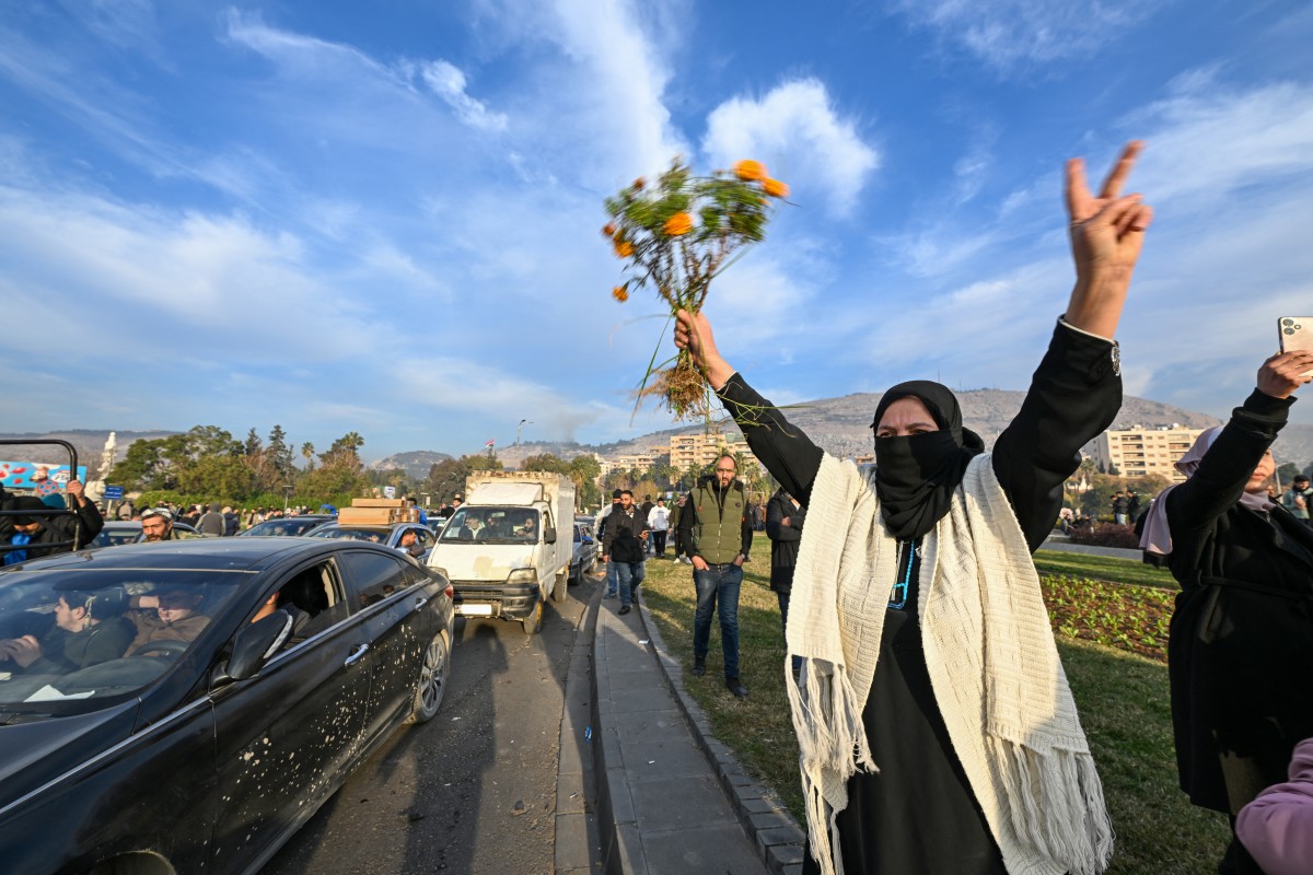 People celebrate at Umayyad Square in Damascus