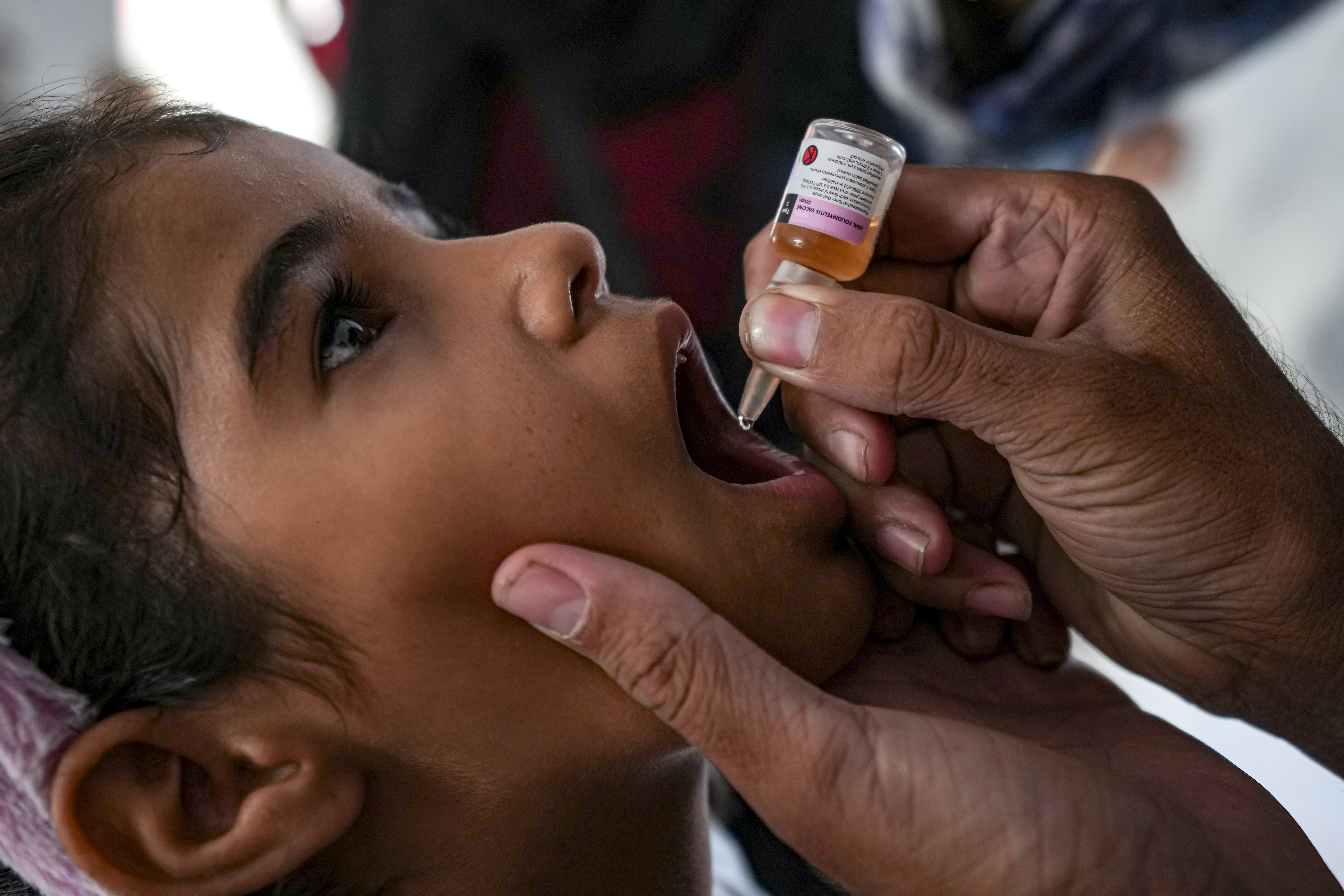 A health worker administers a polio vaccine to a child at a hospital in Deir al-Balah, central Gaza Strip, Sunday, Sept. 1, 2024 [File: Abdel Kareem Hana/AP]