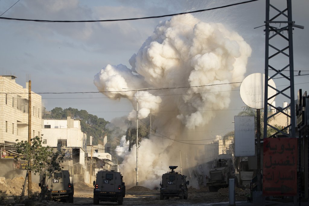 An explosive devise planted by Palestinian militants explodes after being detonated by Israeli soldiers during a military raid in the Nur Shams refugee camp near the West Bank city of Tulkarem, Tuesday, Dec. 24, 2024. (AP Photo/Majdi Mohammed)