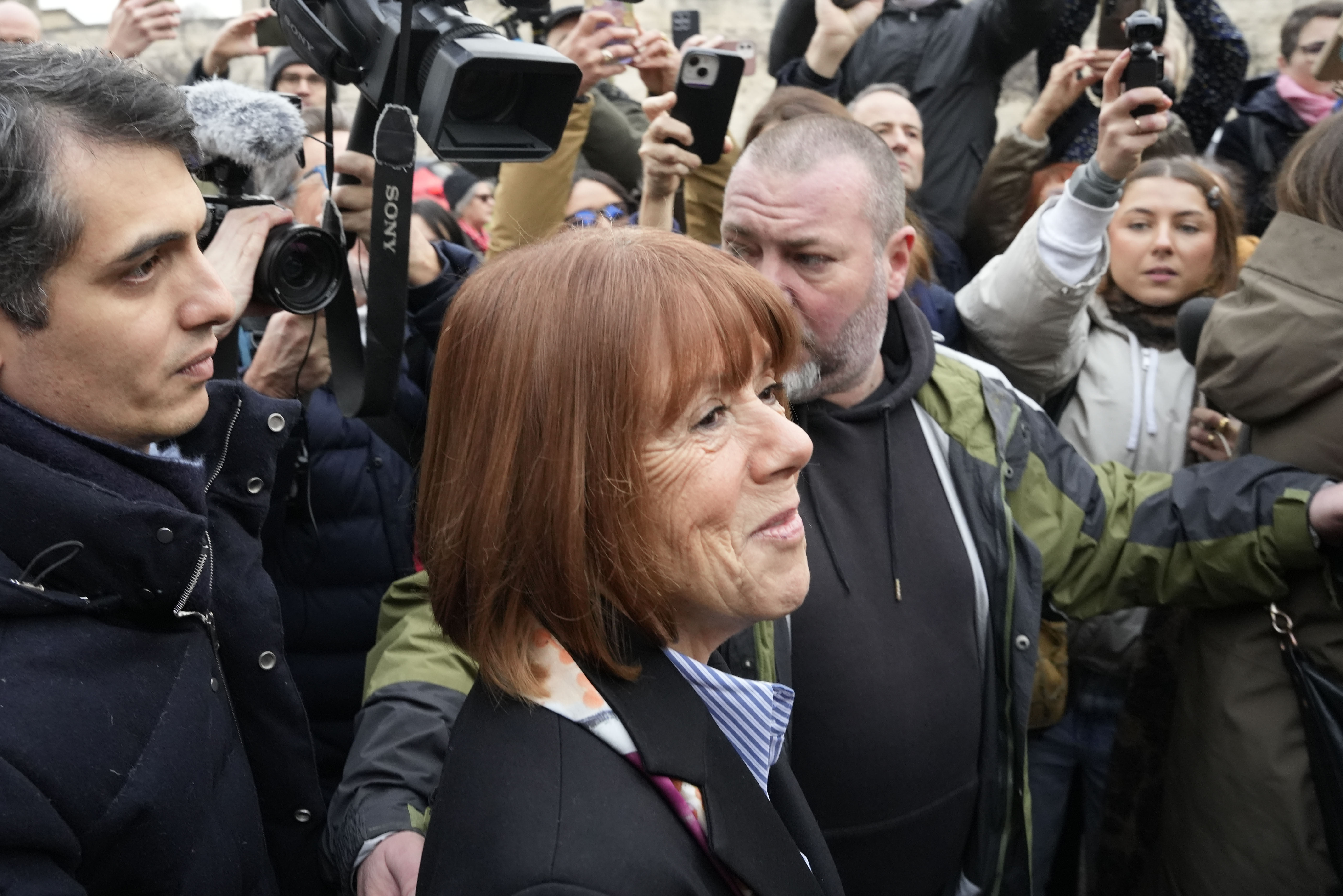 Gisele Pelicot arrives with her lawyer, Stephane Babonneau (left), at the courthouse before a verdict is delivered on December 19, 2024 in Avignon, France
