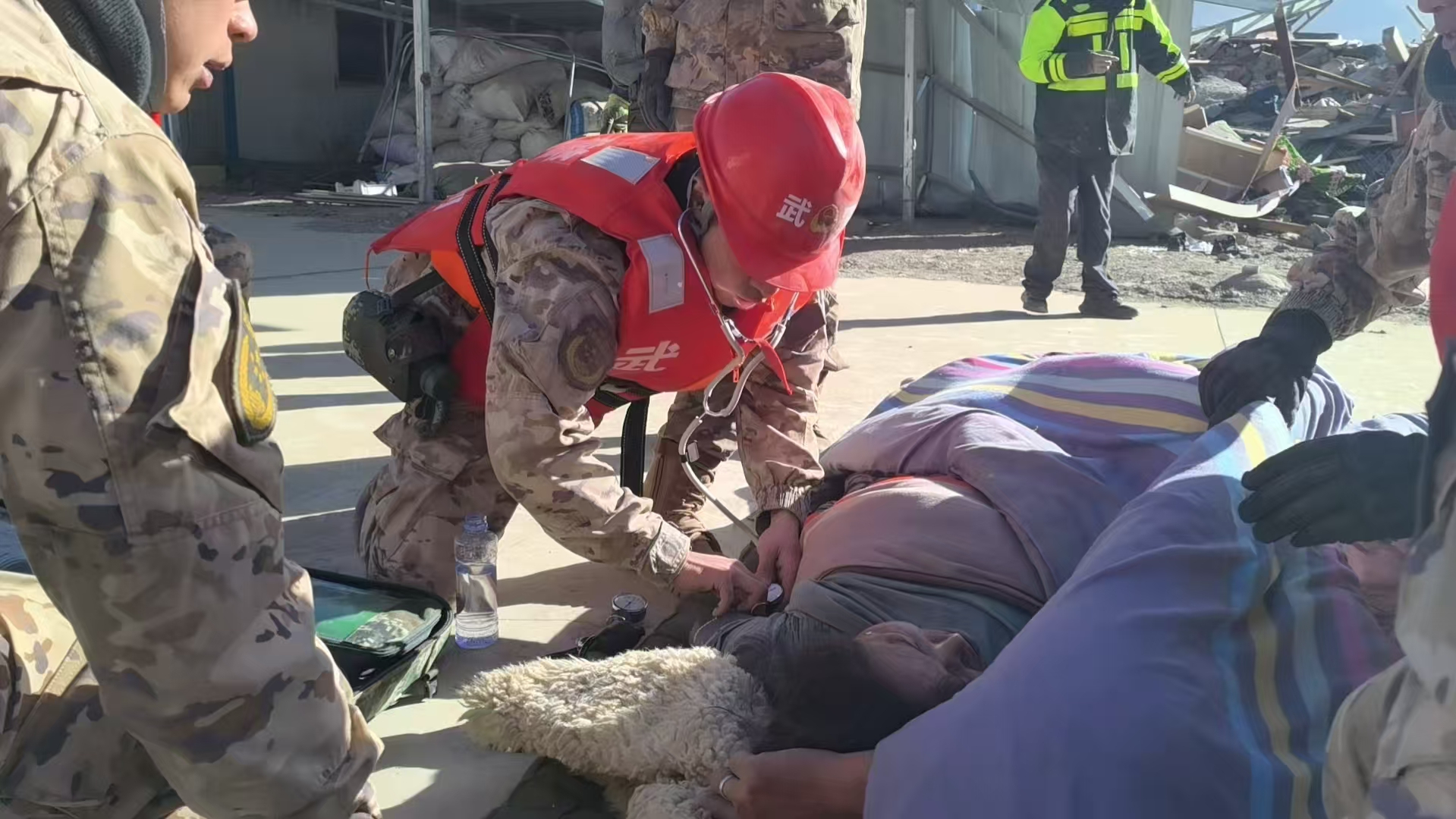 Rescuers attend to an injured person in Changsuo Township of Dingri County in Xigaze, southwest China's Xizang Autonomous Region, 07 January