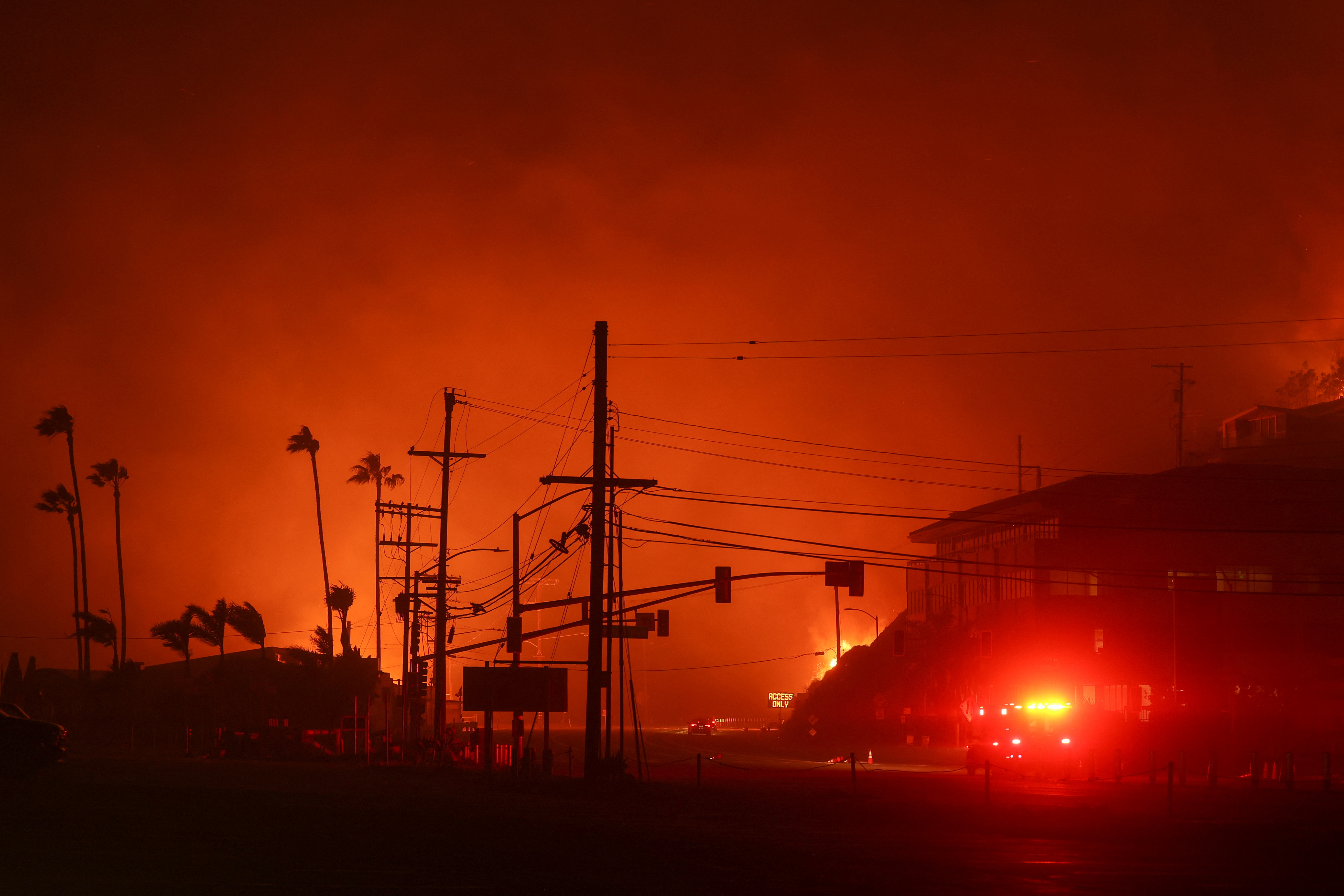 Vehicles drive along the Pacific Coast Highway, as a wildfire burns in the Pacific Palisades neighborhood of west Los Angeles, California, U.S., January 7